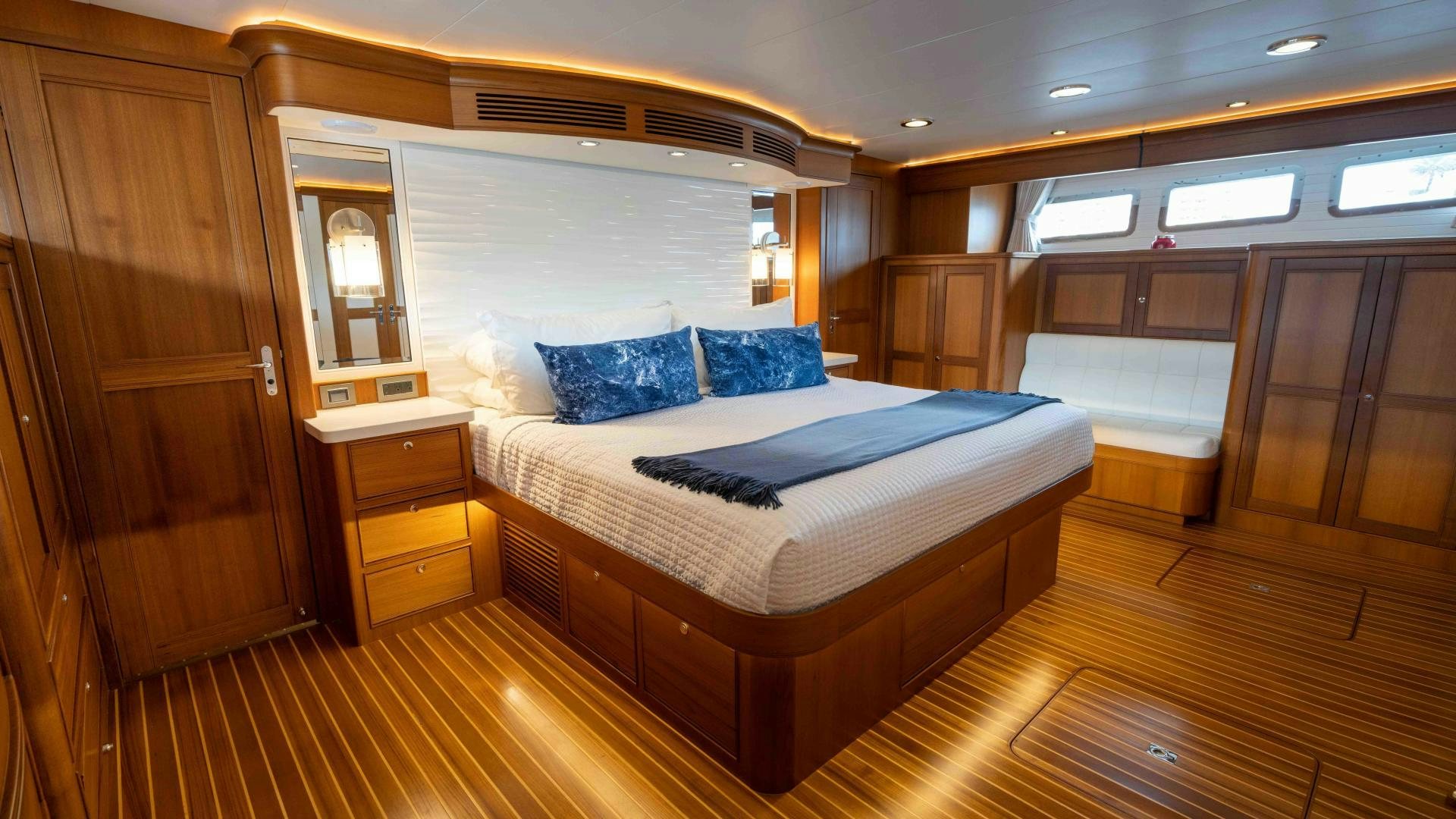 a large bedroom with a wood floor aboard NEVER MY LOVE Yacht for Sale