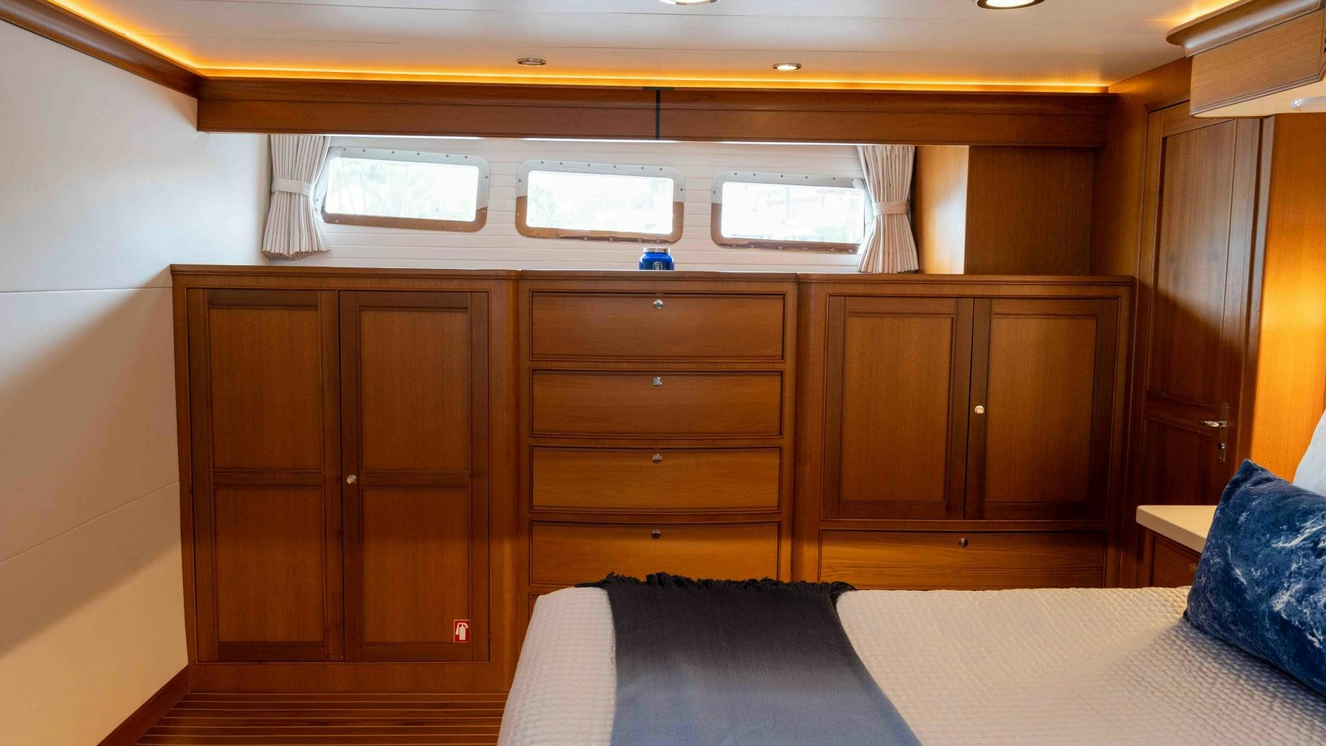 a room with a bed and a desk aboard NEVER MY LOVE Yacht for Sale