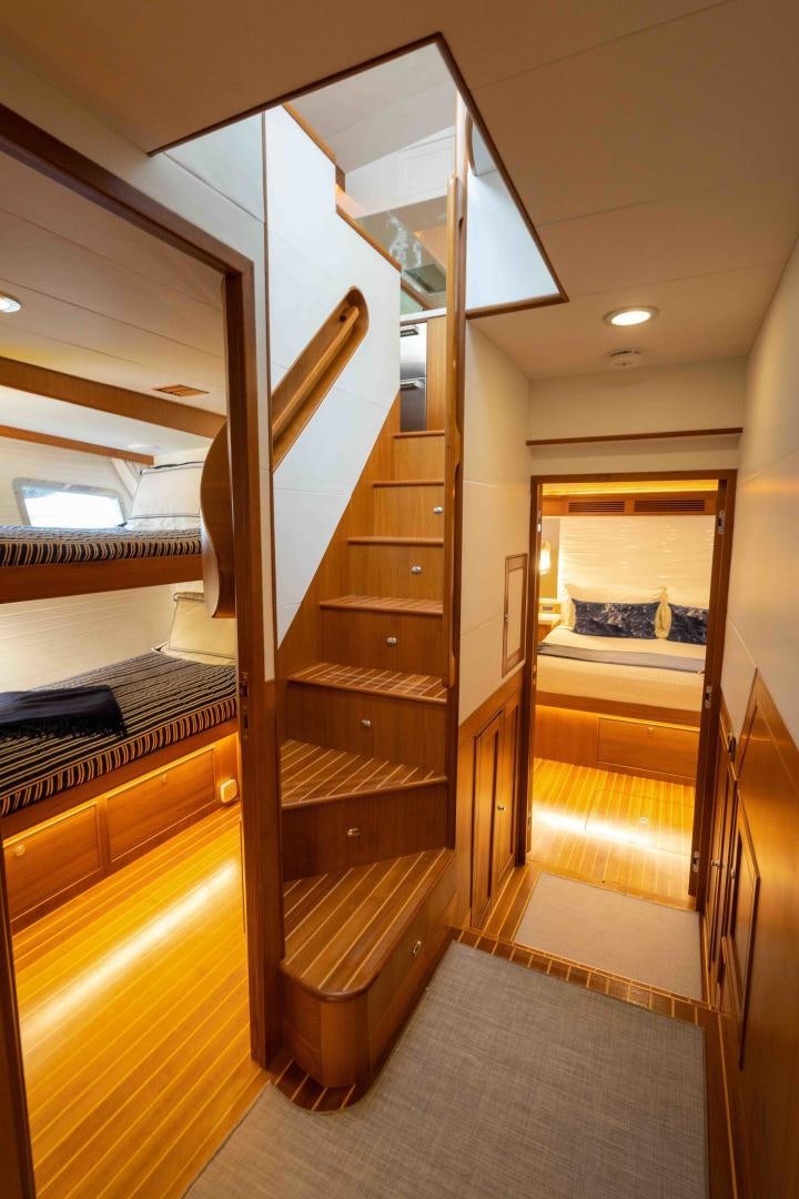 a wood bunk bed in a room aboard NEVER MY LOVE Yacht for Sale