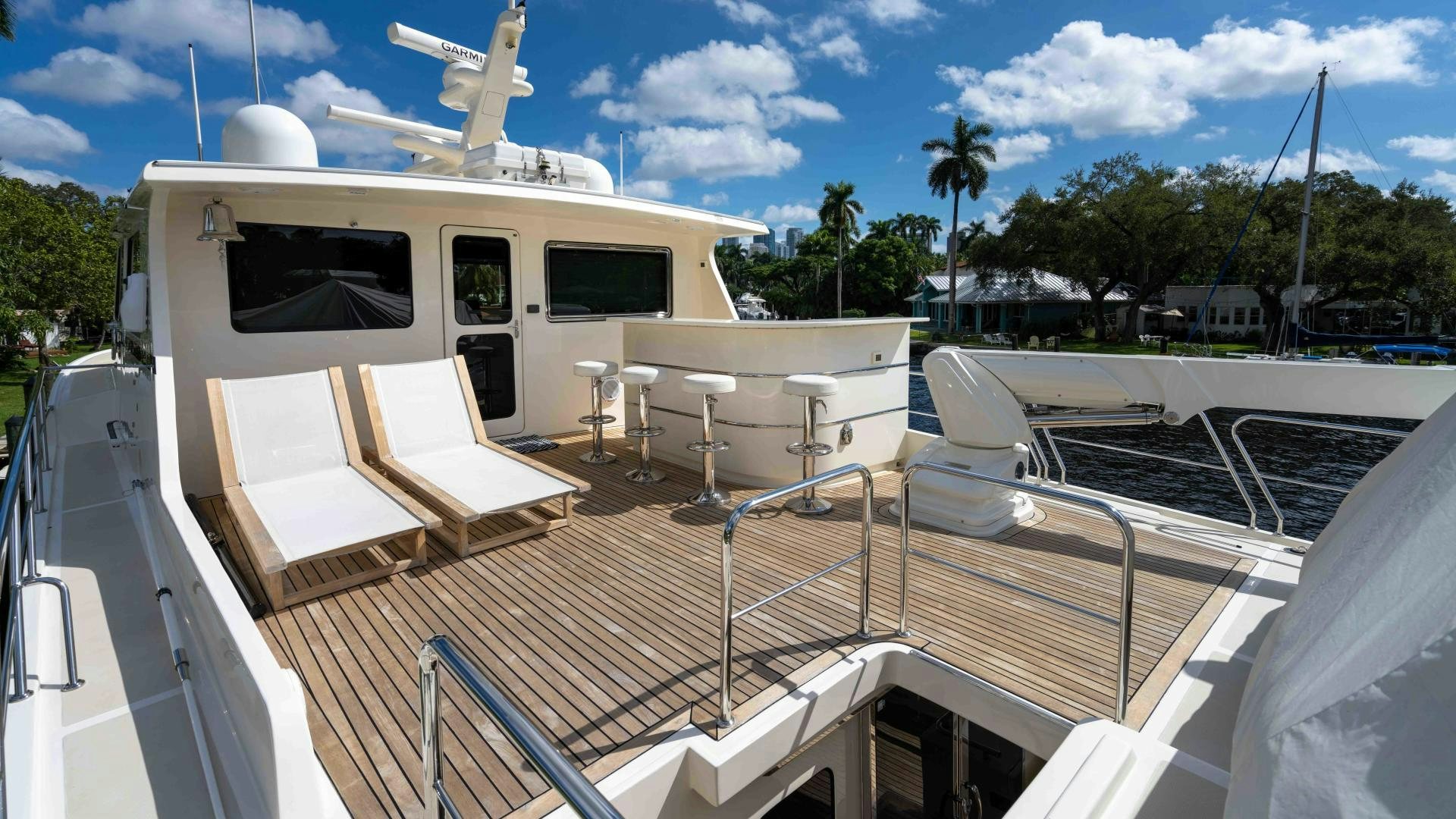 a deck with chairs and tables on it aboard NEVER MY LOVE Yacht for Sale