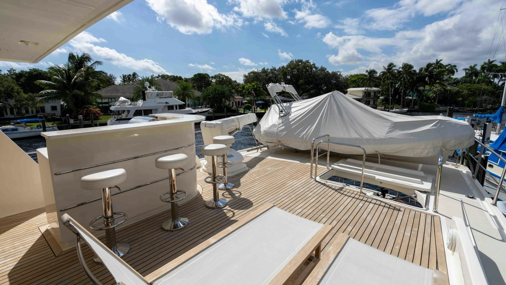 a deck with tables and chairs aboard NEVER MY LOVE Yacht for Sale