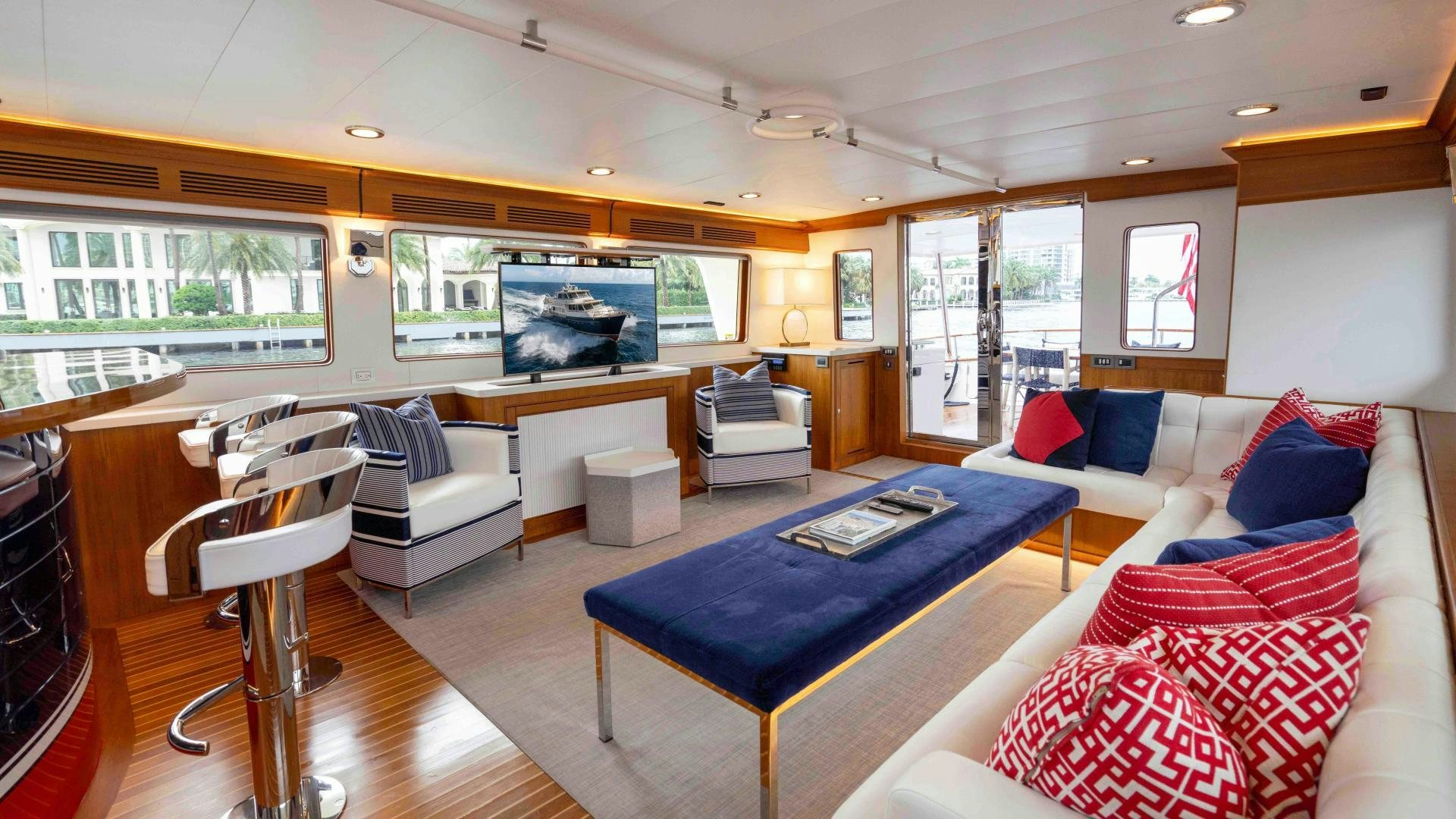 a living room with a blue table and a blue couch aboard NEVER MY LOVE Yacht for Sale