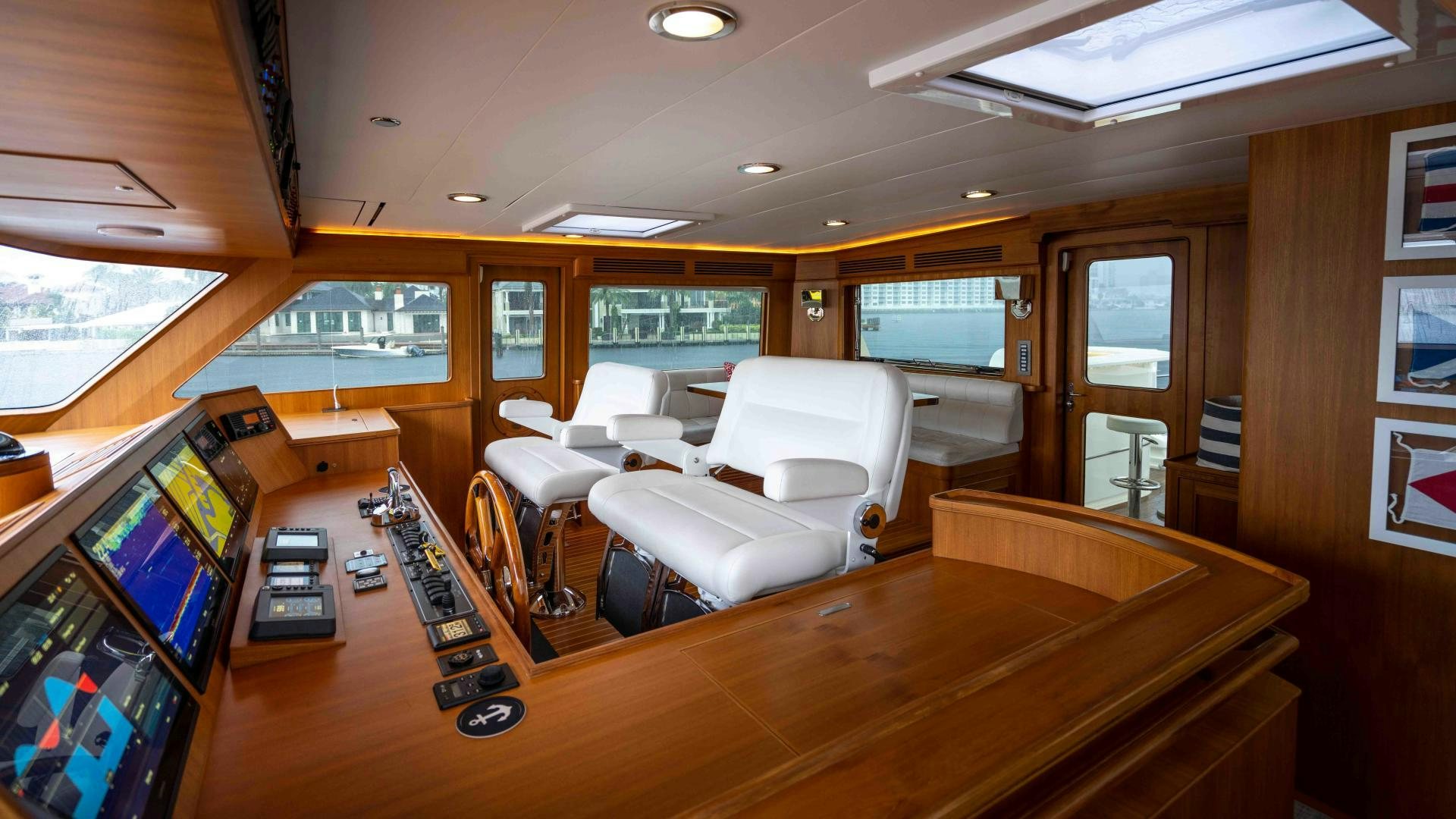 a room with a large table and chairs and a television aboard NEVER MY LOVE Yacht for Sale