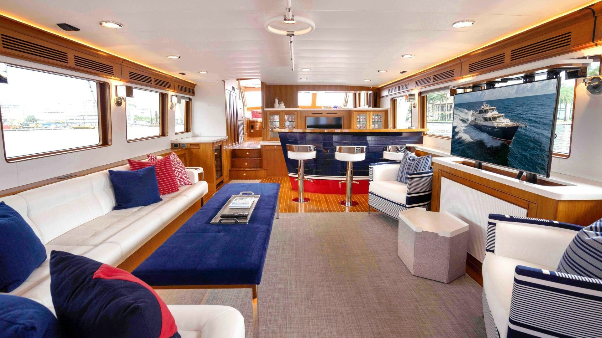 a living room with a large screen aboard NEVER MY LOVE Yacht for Sale