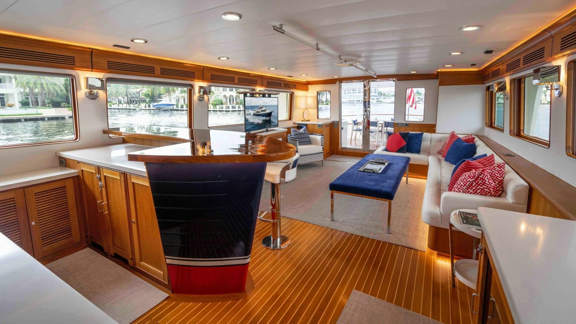 a large living room with a large table and a large window aboard NEVER MY LOVE Yacht for Sale