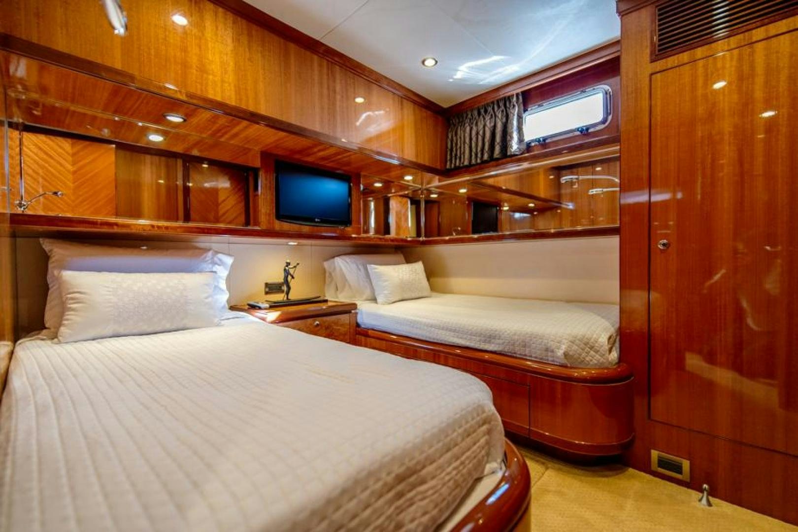a room with a bed and a tv aboard LODESTAR Yacht for Sale