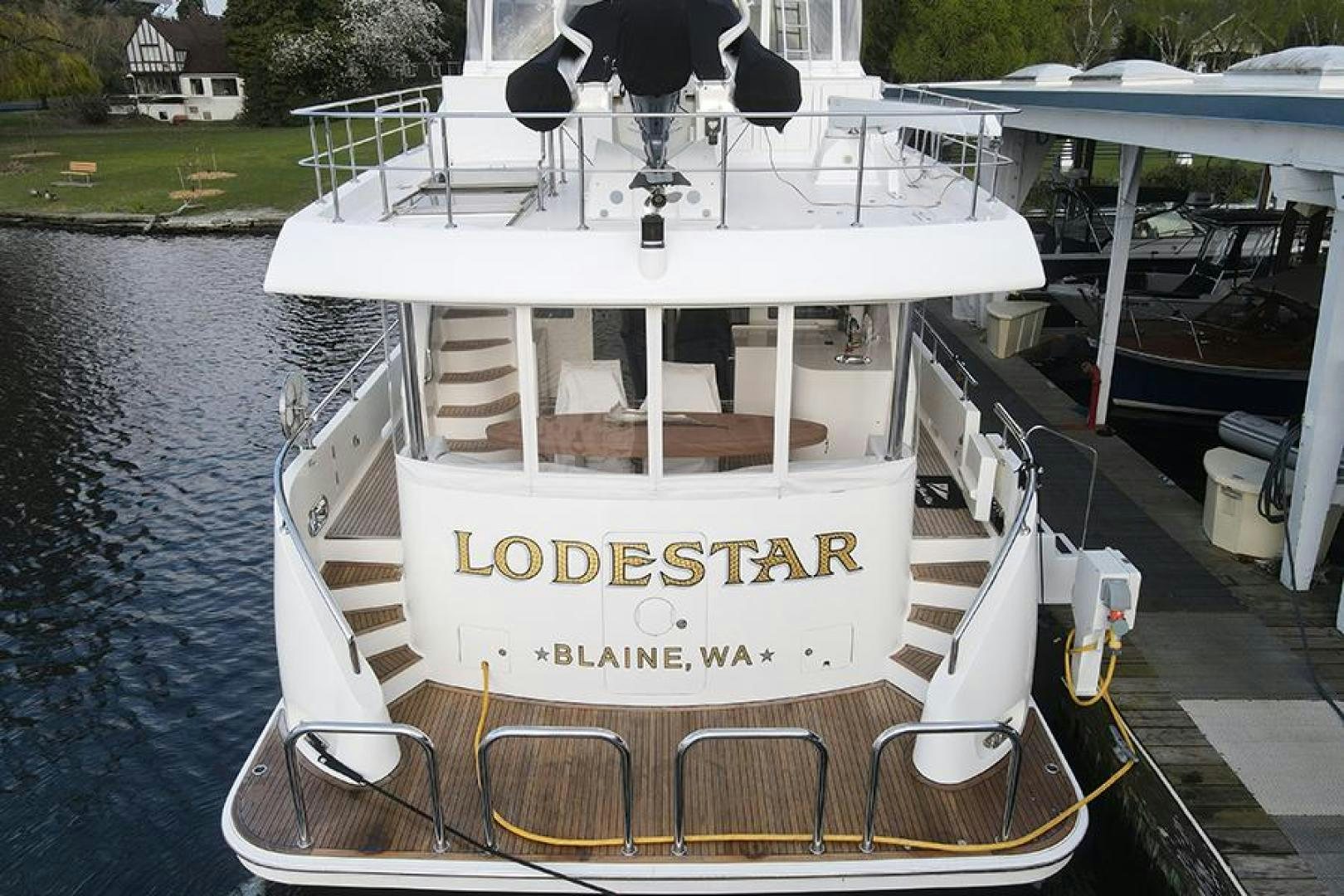 a white boat docked aboard LODESTAR Yacht for Sale