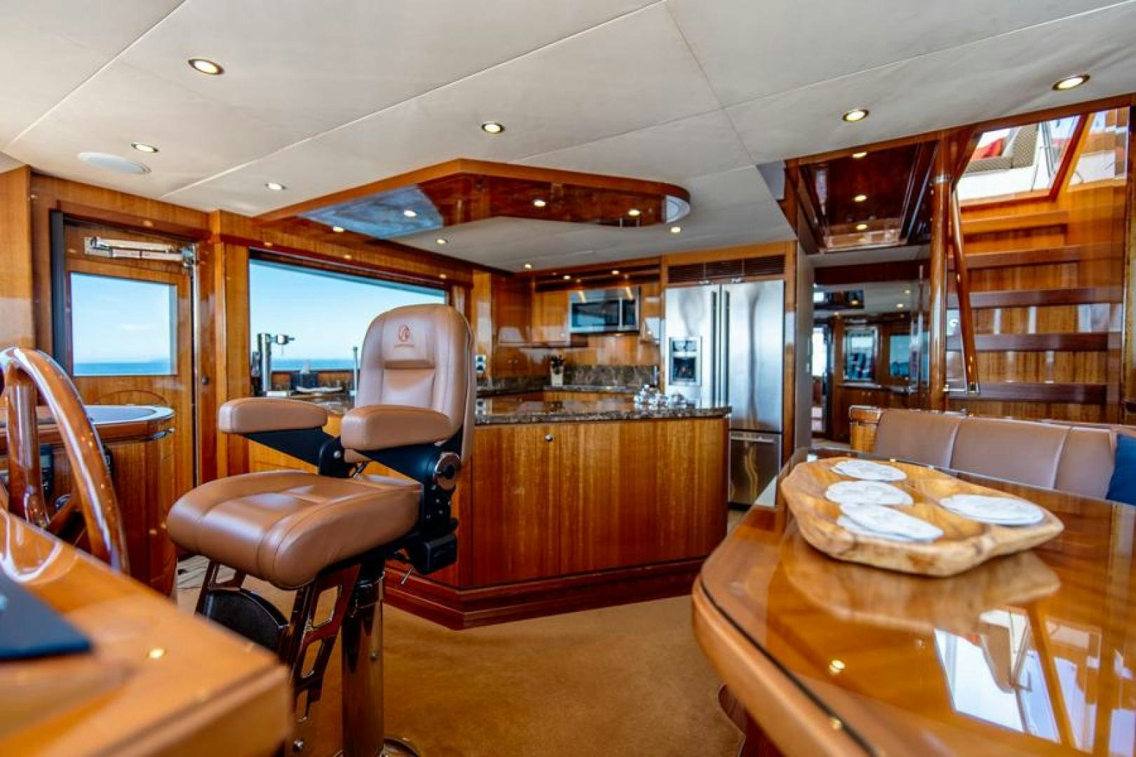 a room with a table chairs and a wood cabinet aboard LODESTAR Yacht for Sale