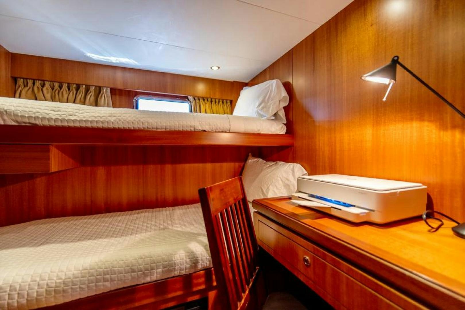 a bed with a desk and a printer on it aboard LODESTAR Yacht for Sale