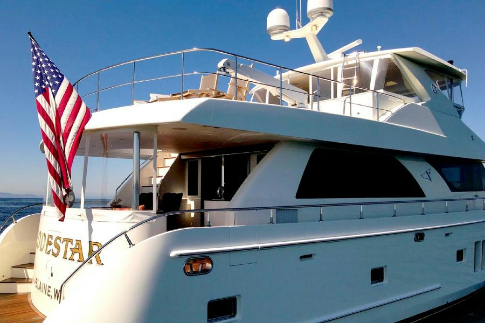 a boat with a flag on the front aboard LODESTAR Yacht for Sale