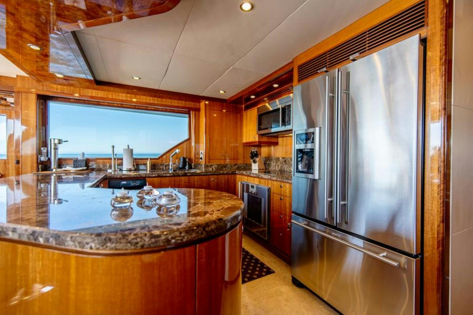 a kitchen with a stainless steel refrigerator aboard LODESTAR Yacht for Sale