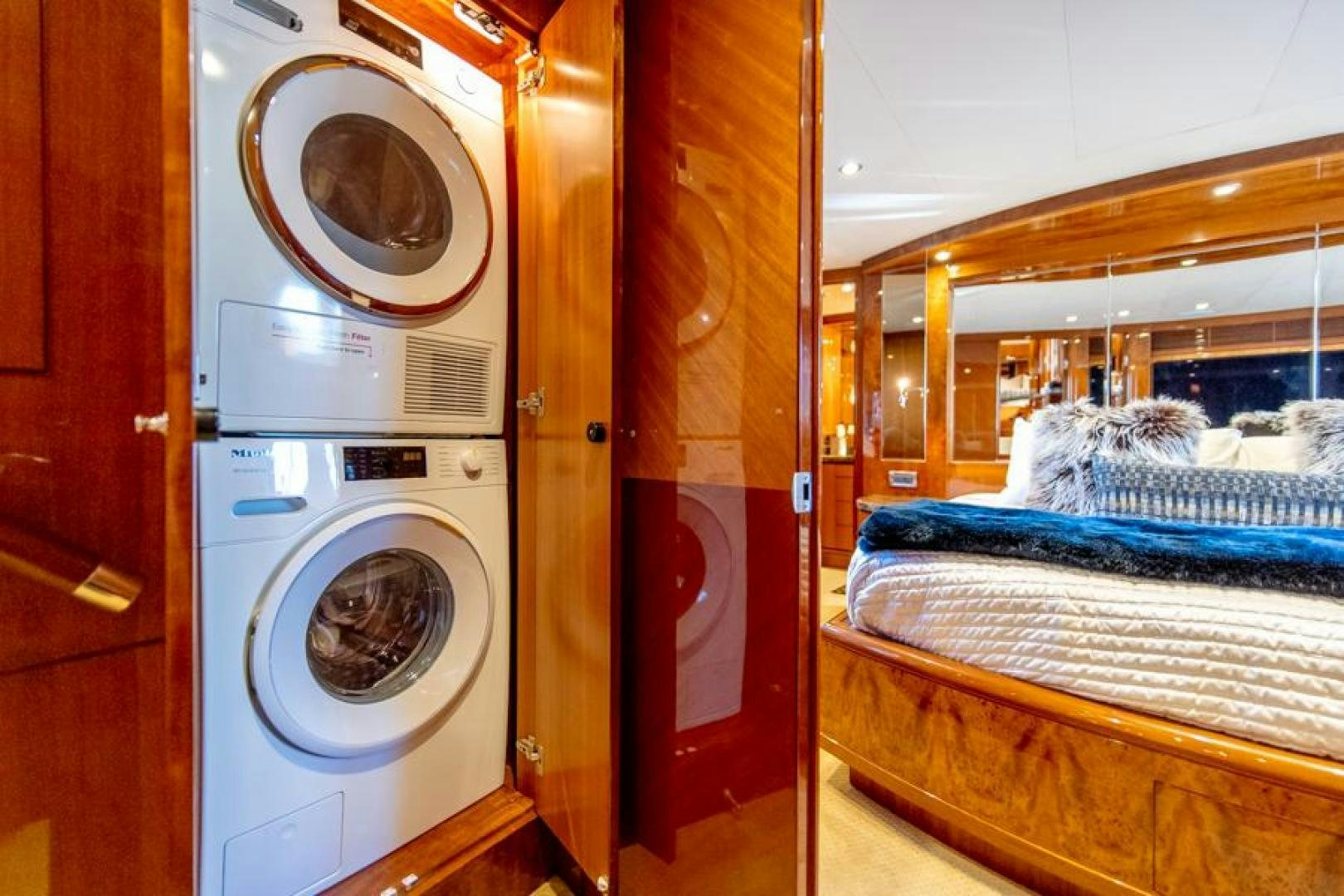 a room with a washing machine and a bed aboard LODESTAR Yacht for Sale
