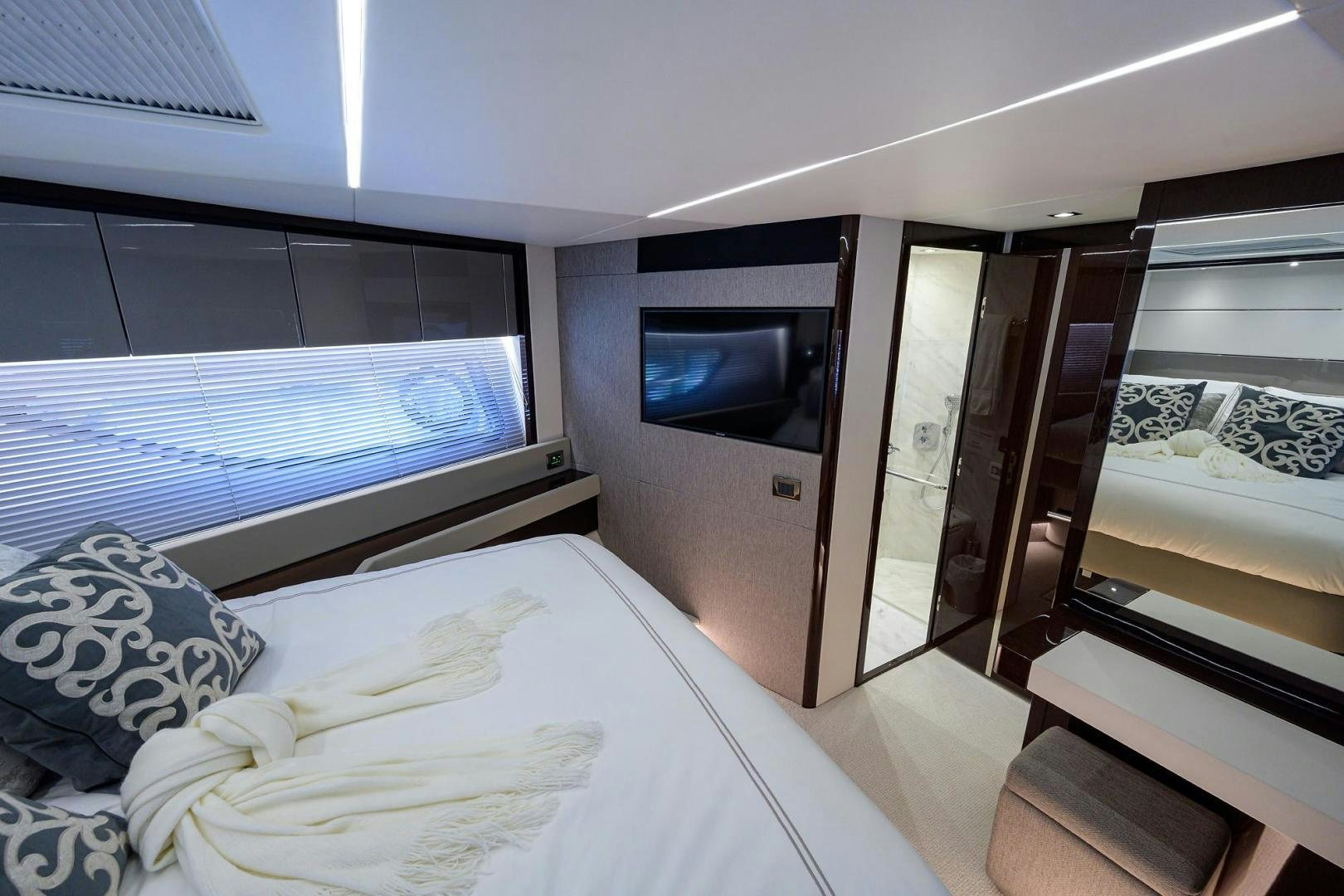 a bedroom with a bed and a tv aboard NIGHT STAR Yacht for Sale