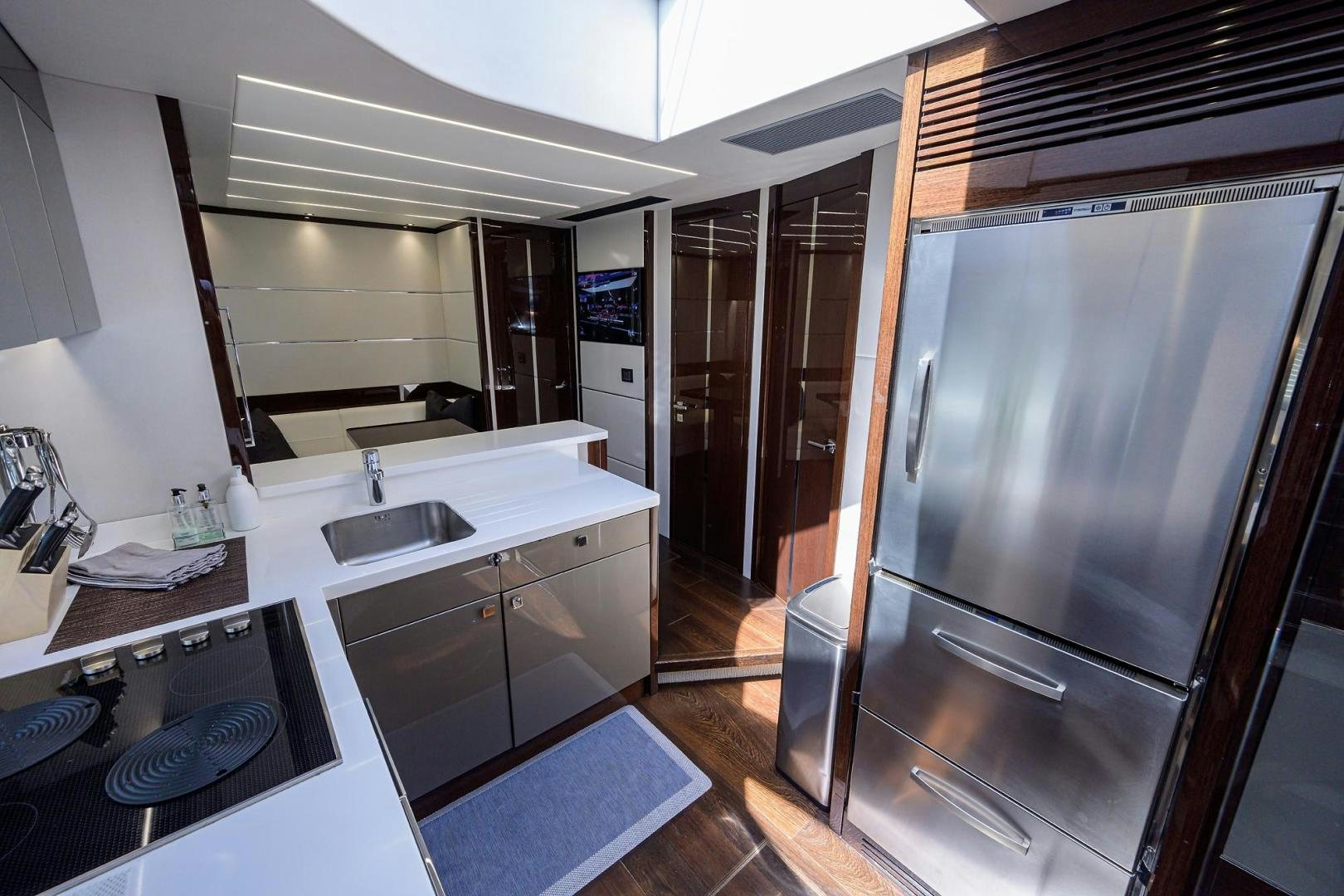 a kitchen with a large refrigerator aboard NIGHT STAR Yacht for Sale