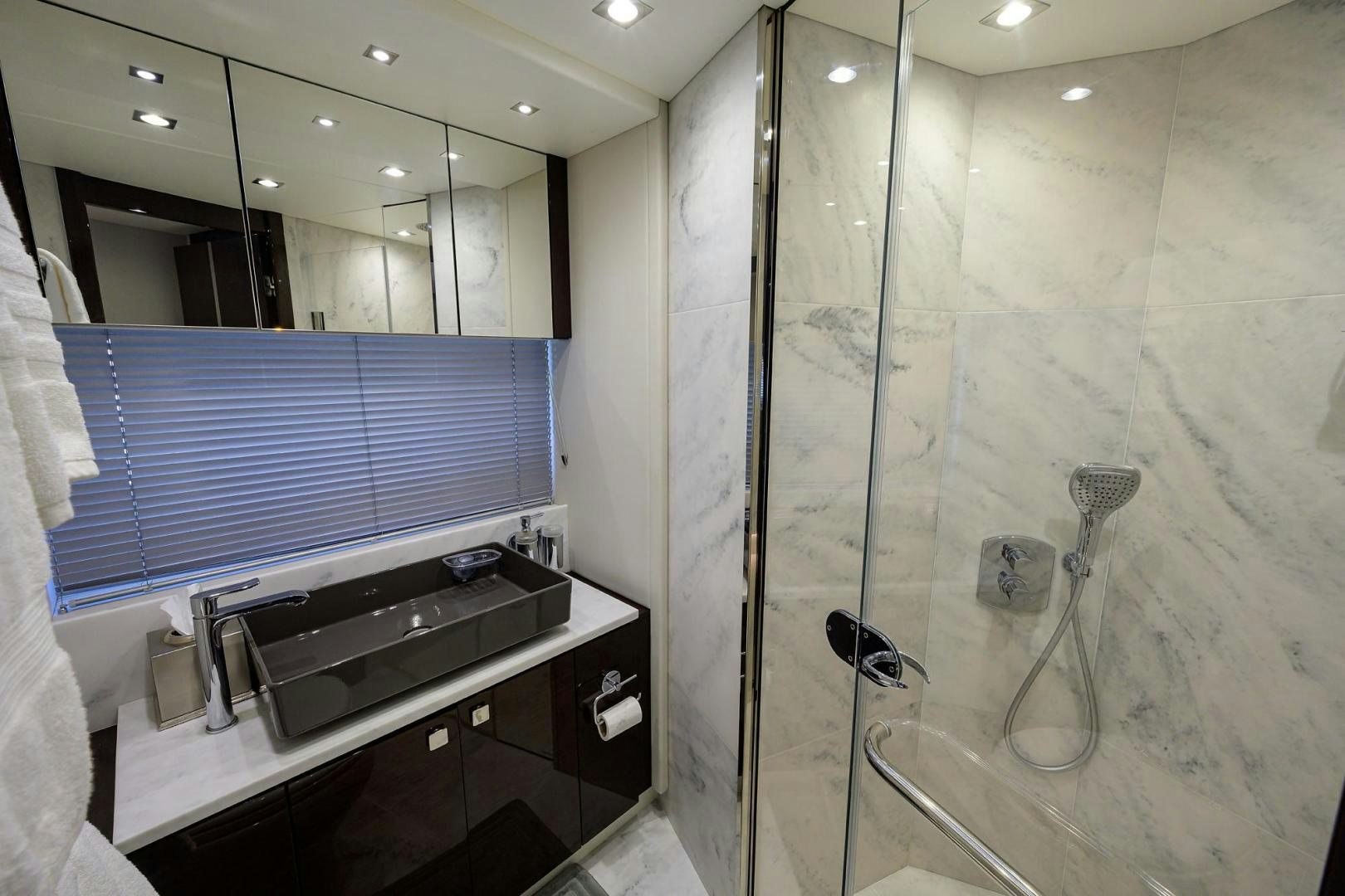 a bathroom with a glass shower aboard NIGHT STAR Yacht for Sale
