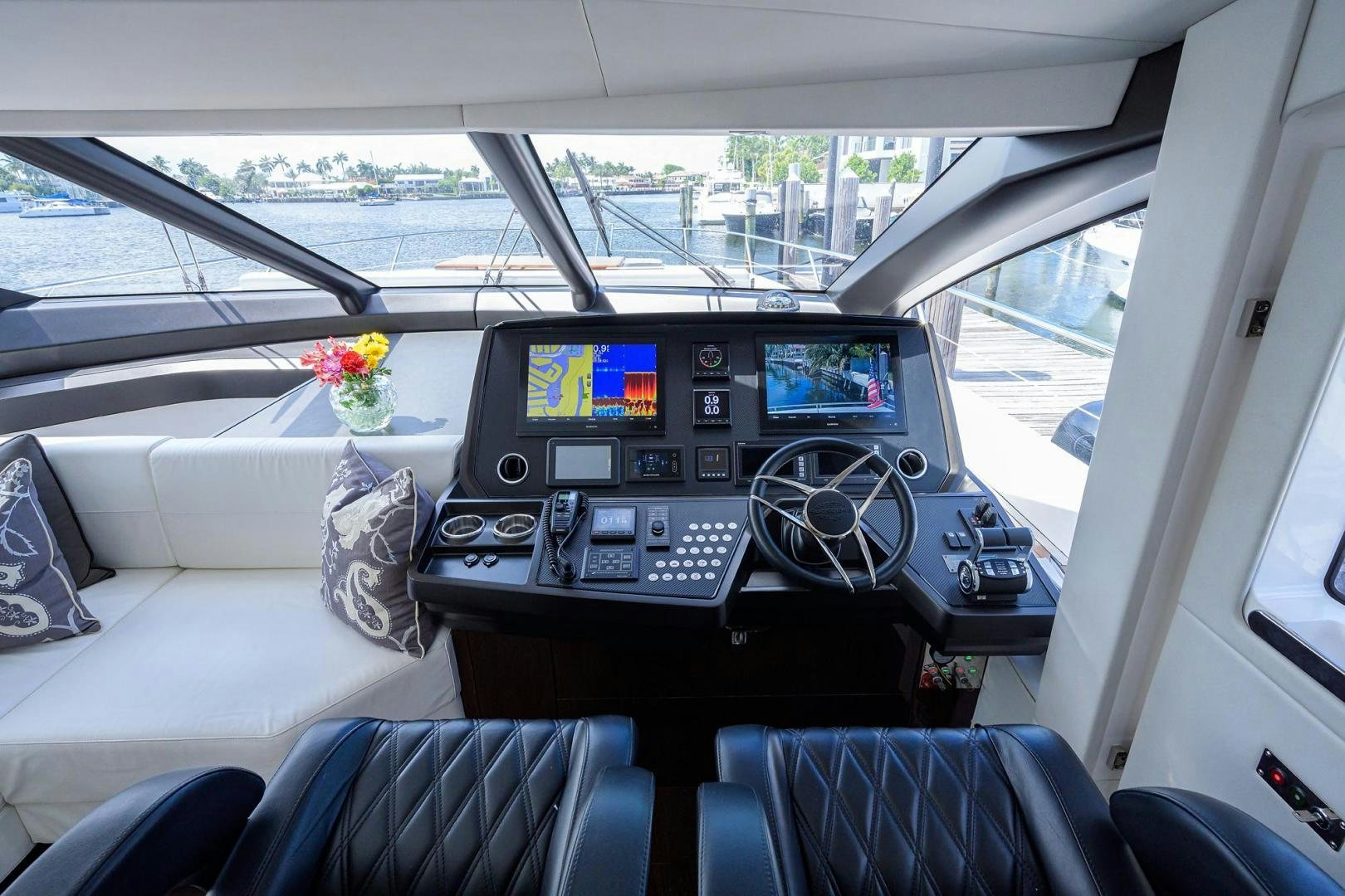 inside of a car with a screen and a keyboard and a flower on the dashboard aboard NIGHT STAR Yacht for Sale