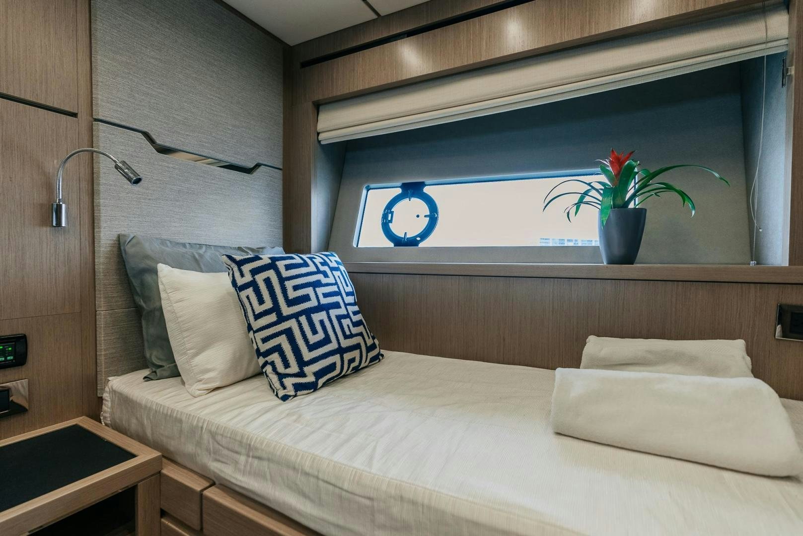 a bed with pillows and a plant aboard GRAVITAS Yacht for Sale