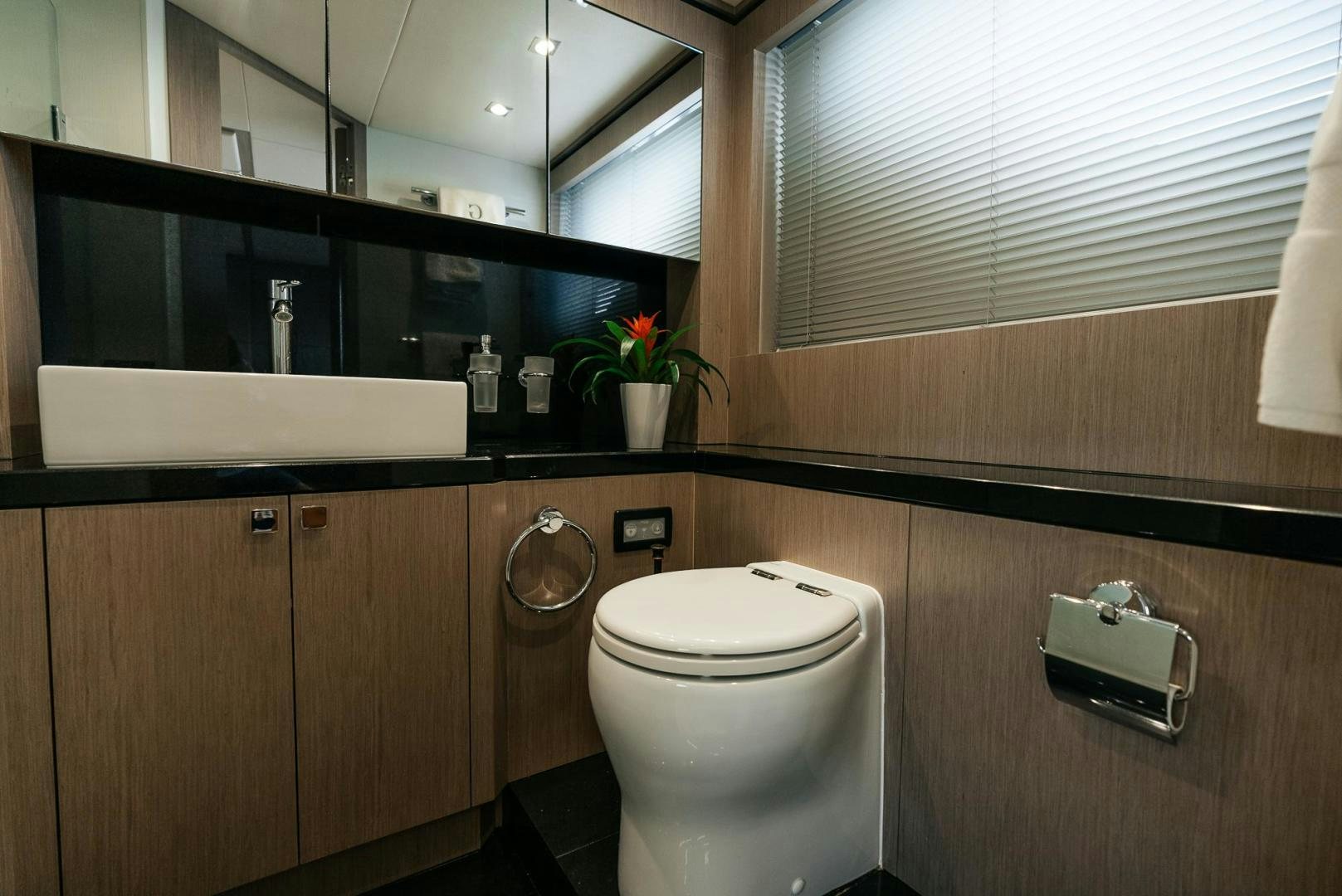 a bathroom with a toilet and a mirror aboard GRAVITAS Yacht for Sale