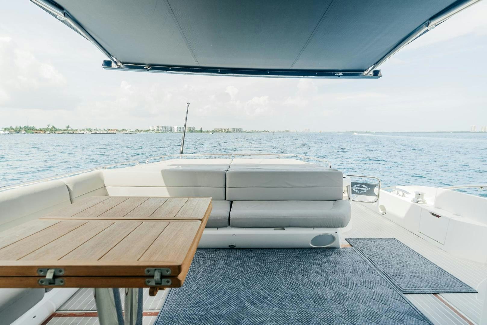 a deck with a view of a city and water aboard GRAVITAS Yacht for Sale