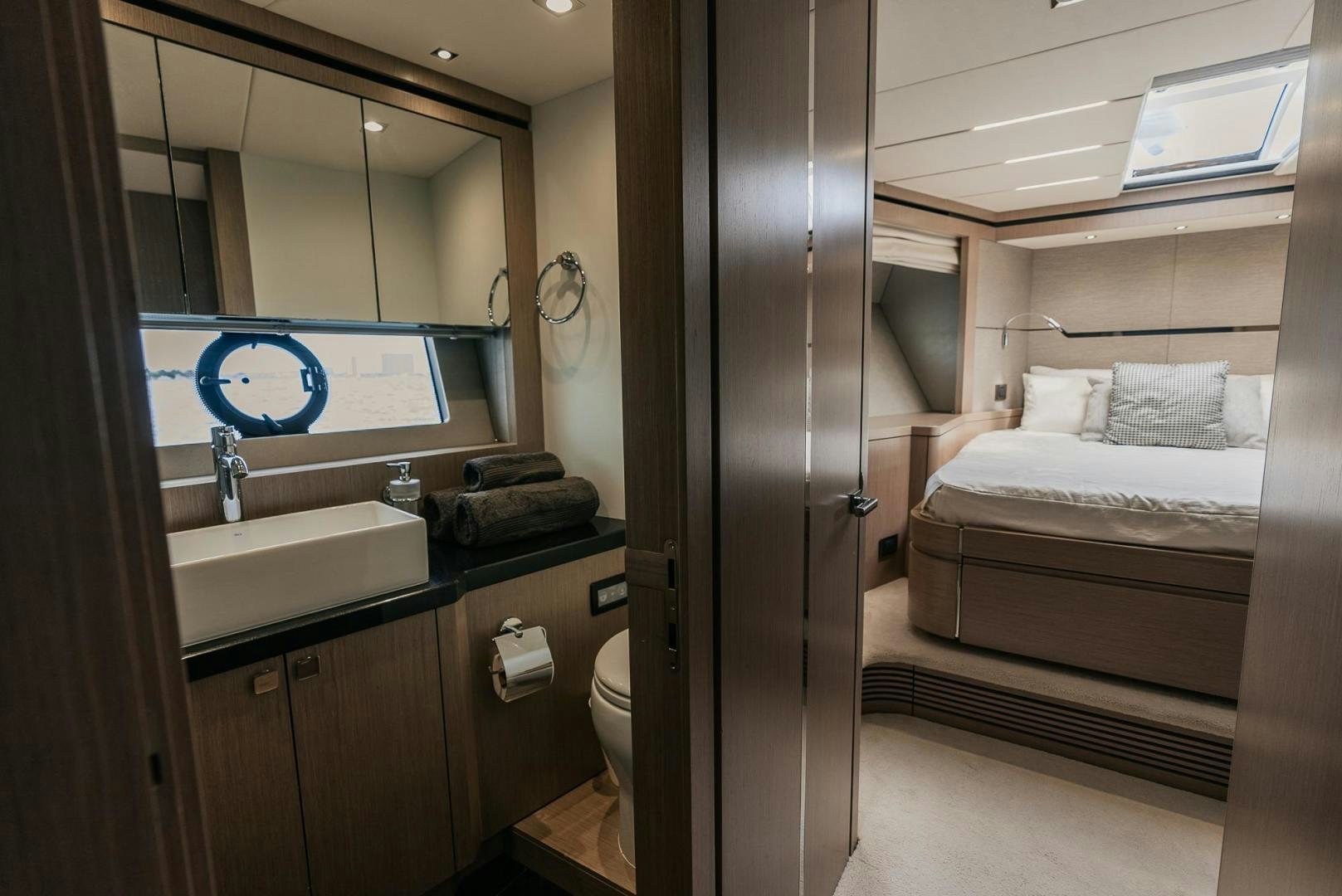 a bathroom with a sink and a bed aboard GRAVITAS Yacht for Sale
