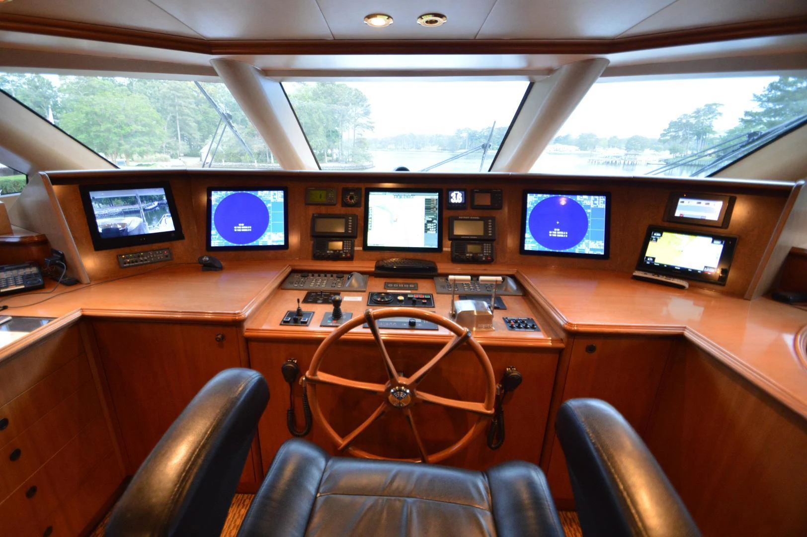 a wooden desk with a chair and computer screens aboard JOAN'S ARK Yacht for Sale
