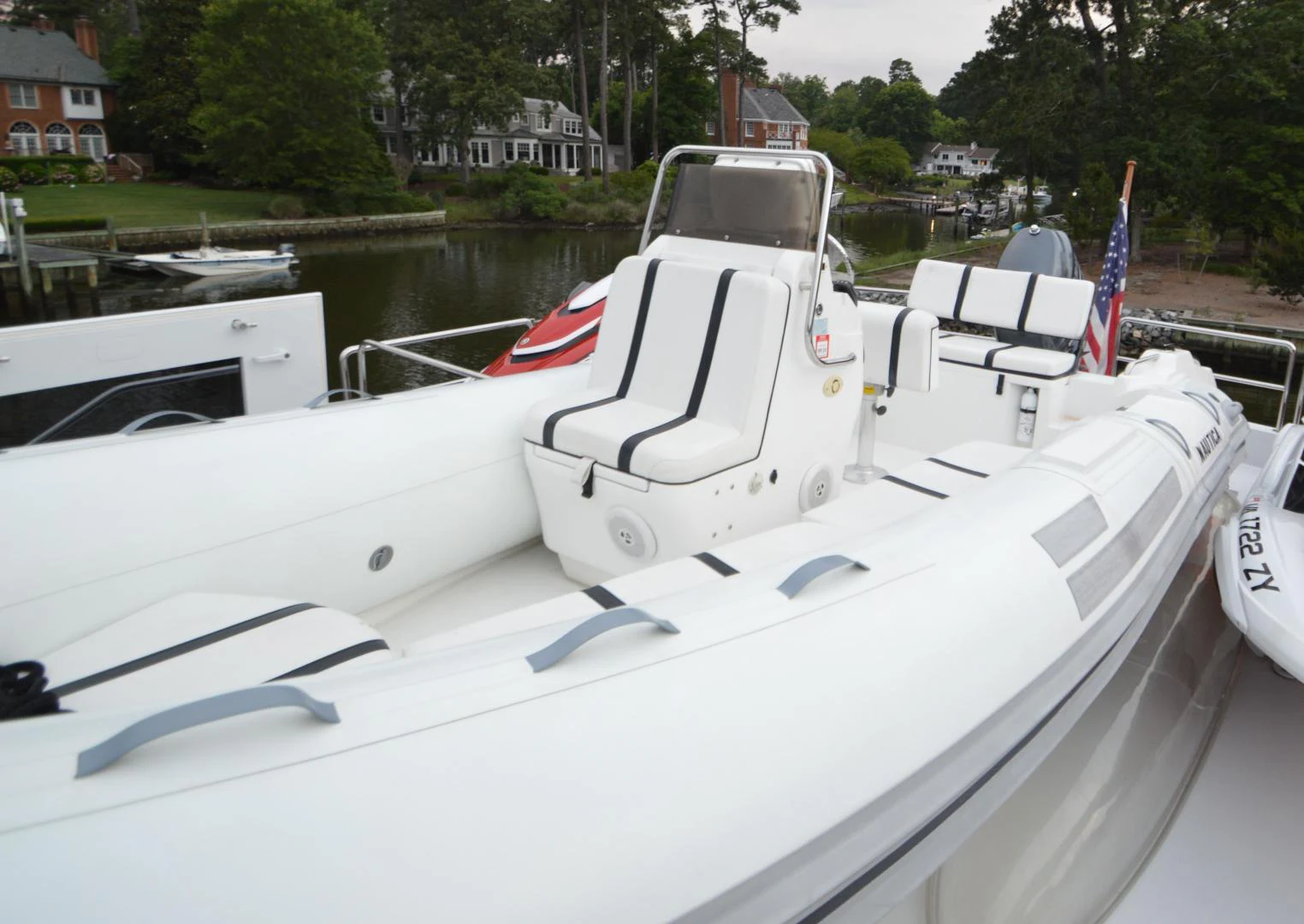 a boat with a flag on the front aboard JOAN'S ARK Yacht for Sale