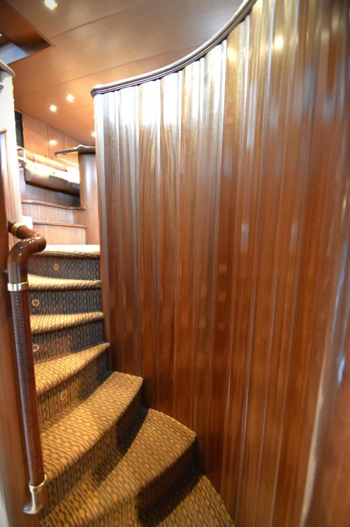 a staircase with wood railings aboard JOAN'S ARK Yacht for Sale