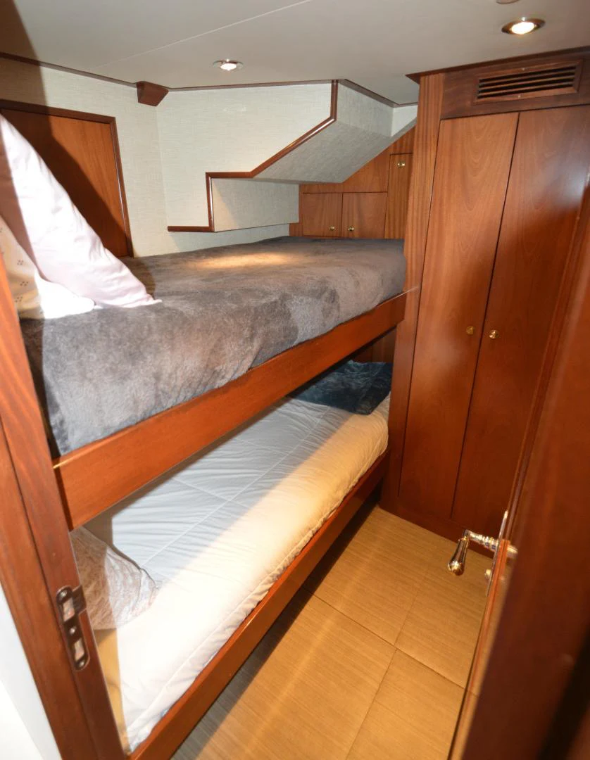 a bed with a wooden headboard aboard JOAN'S ARK Yacht for Sale