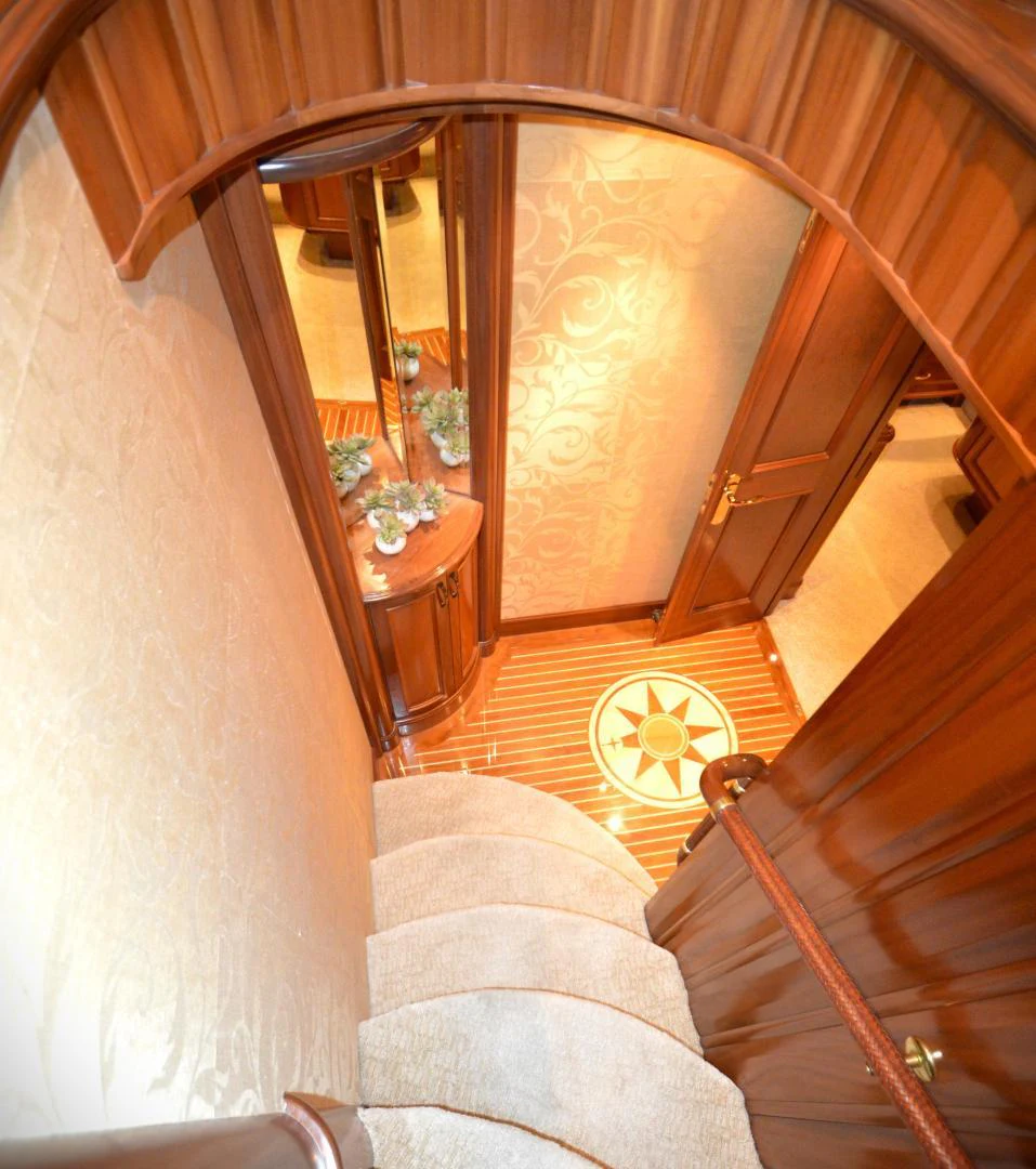 a staircase with a glass window aboard JOAN'S ARK Yacht for Sale
