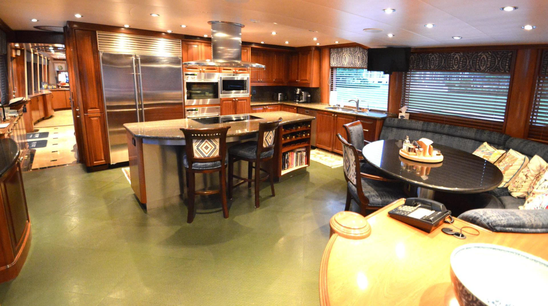 a kitchen with a bar and a table aboard JOAN'S ARK Yacht for Sale