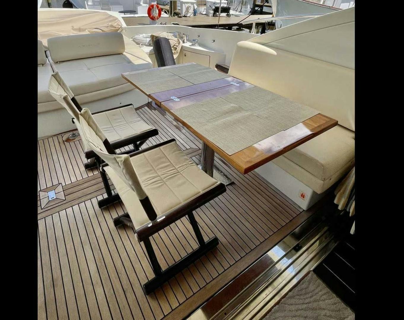 a room with a table and chairs aboard ARTISTIC Yacht for Sale
