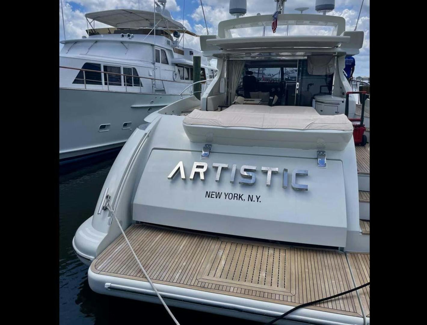 a white boat with a label aboard ARTISTIC Yacht for Sale
