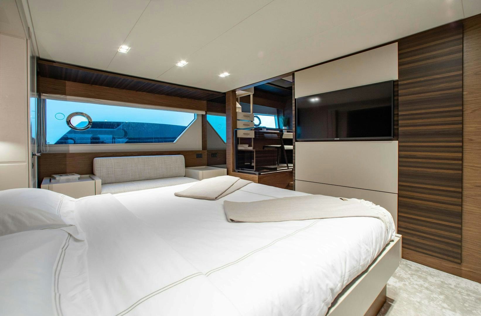 a room with a bed and a television aboard Ferretti 670 Yacht for Sale