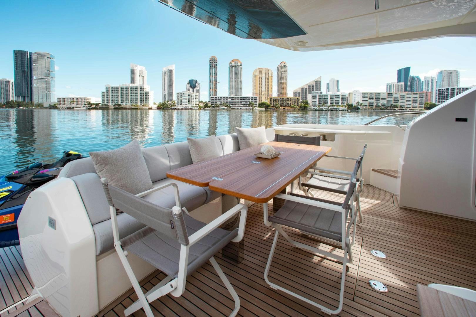 a table and chairs on a deck overlooking a city aboard Ferretti 670 Yacht for Sale