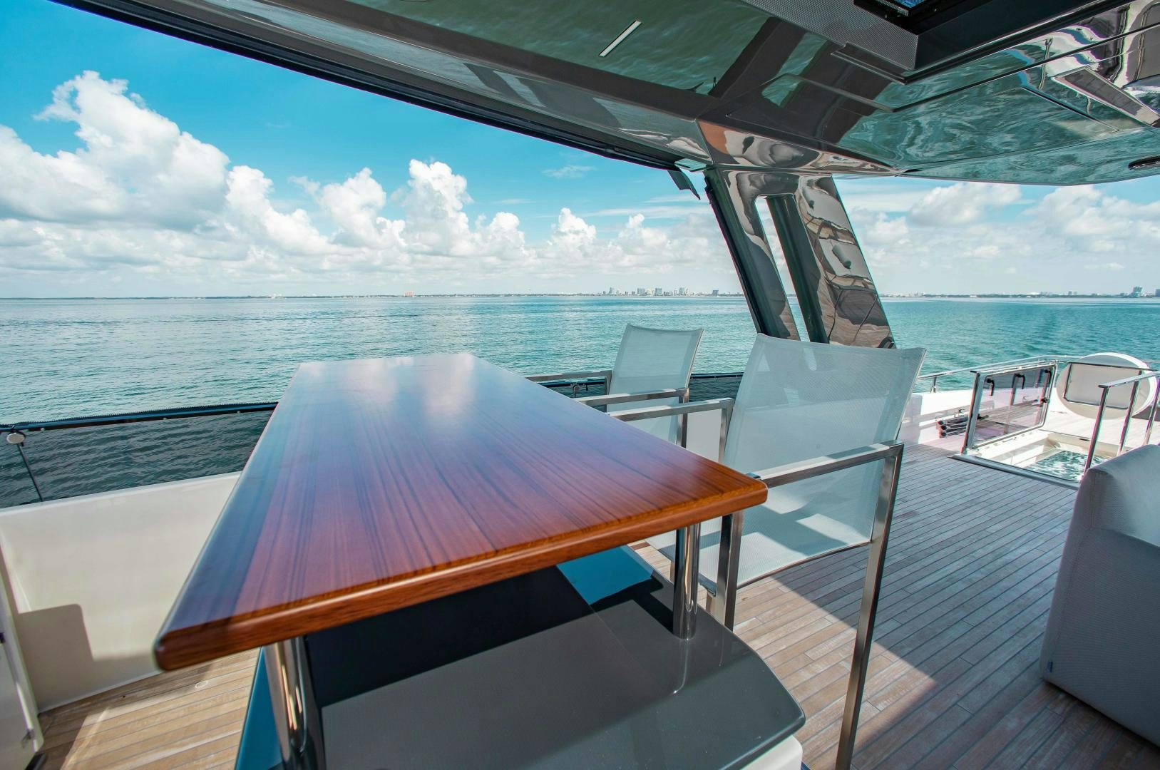 a table and chairs on a deck overlooking the ocean aboard CRAZY Yacht for Sale