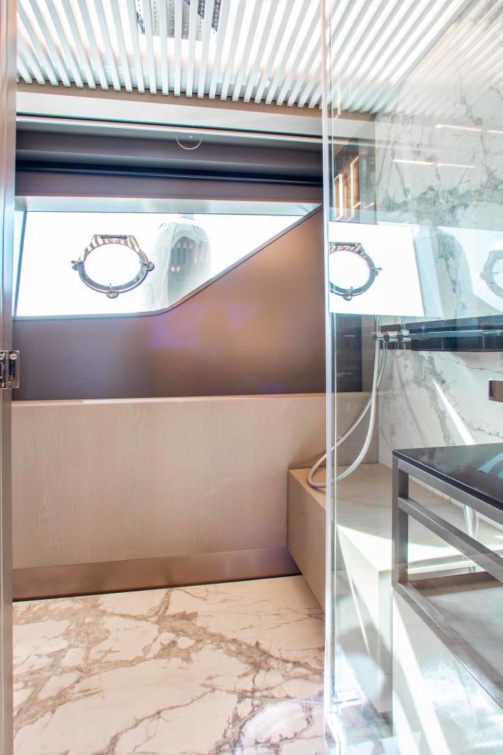 a room with a glass wall and a window aboard CRAZY Yacht for Sale