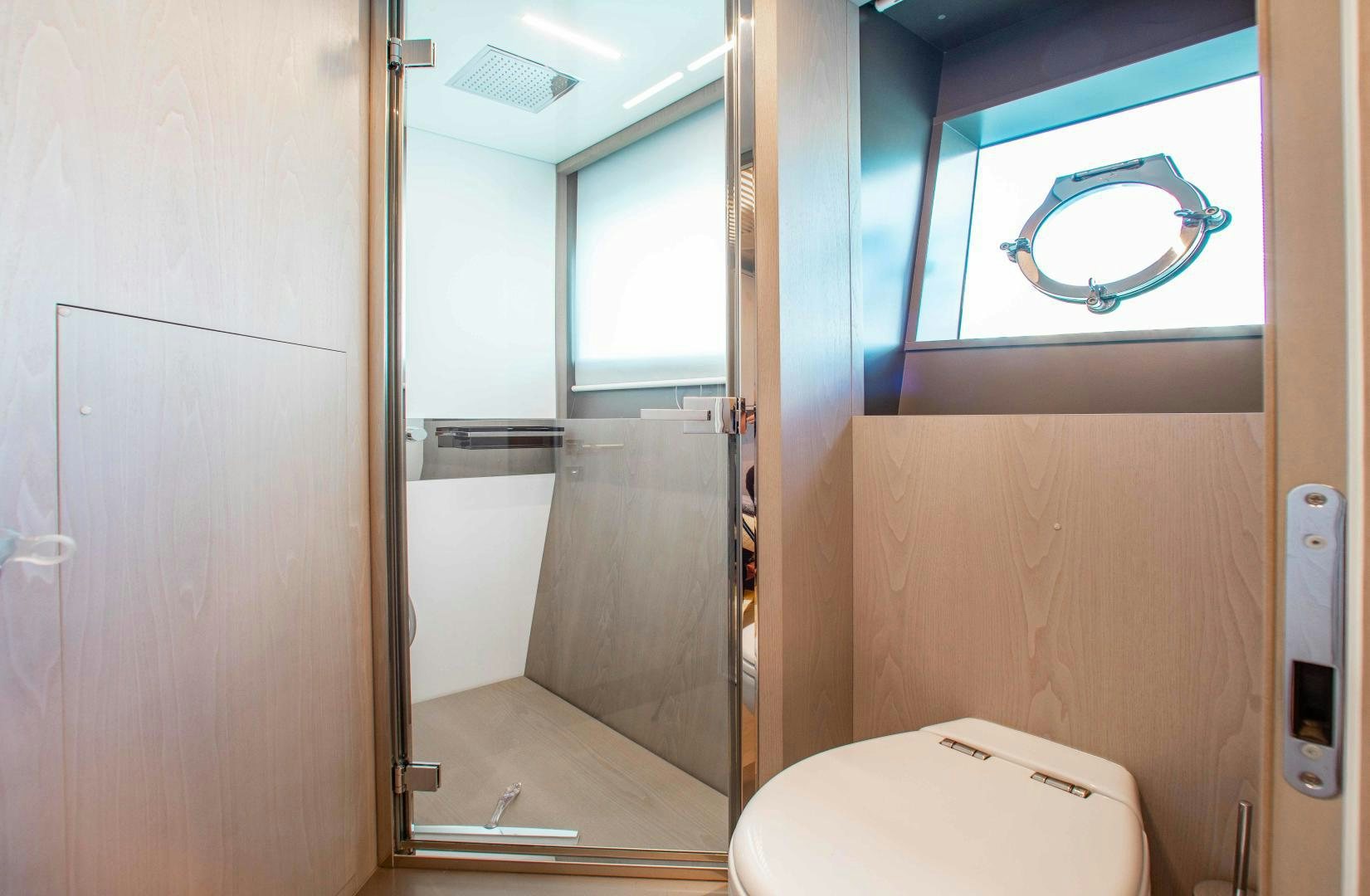 a bathroom with a glass door aboard CRAZY Yacht for Sale