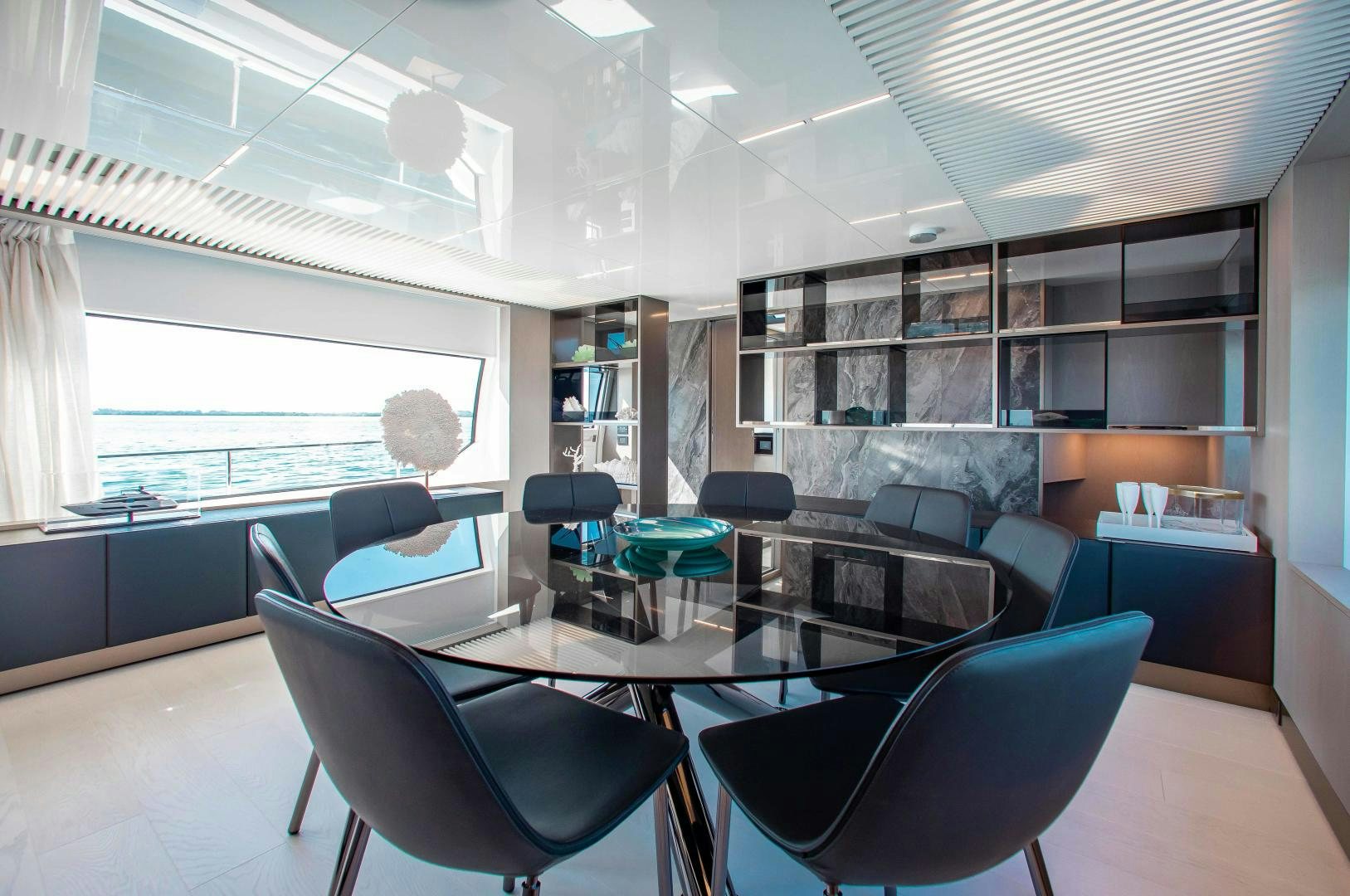 a room with a table and chairs aboard CRAZY Yacht for Sale