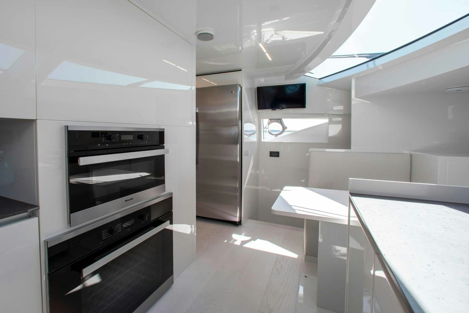a kitchen with white cabinets aboard CRAZY Yacht for Sale