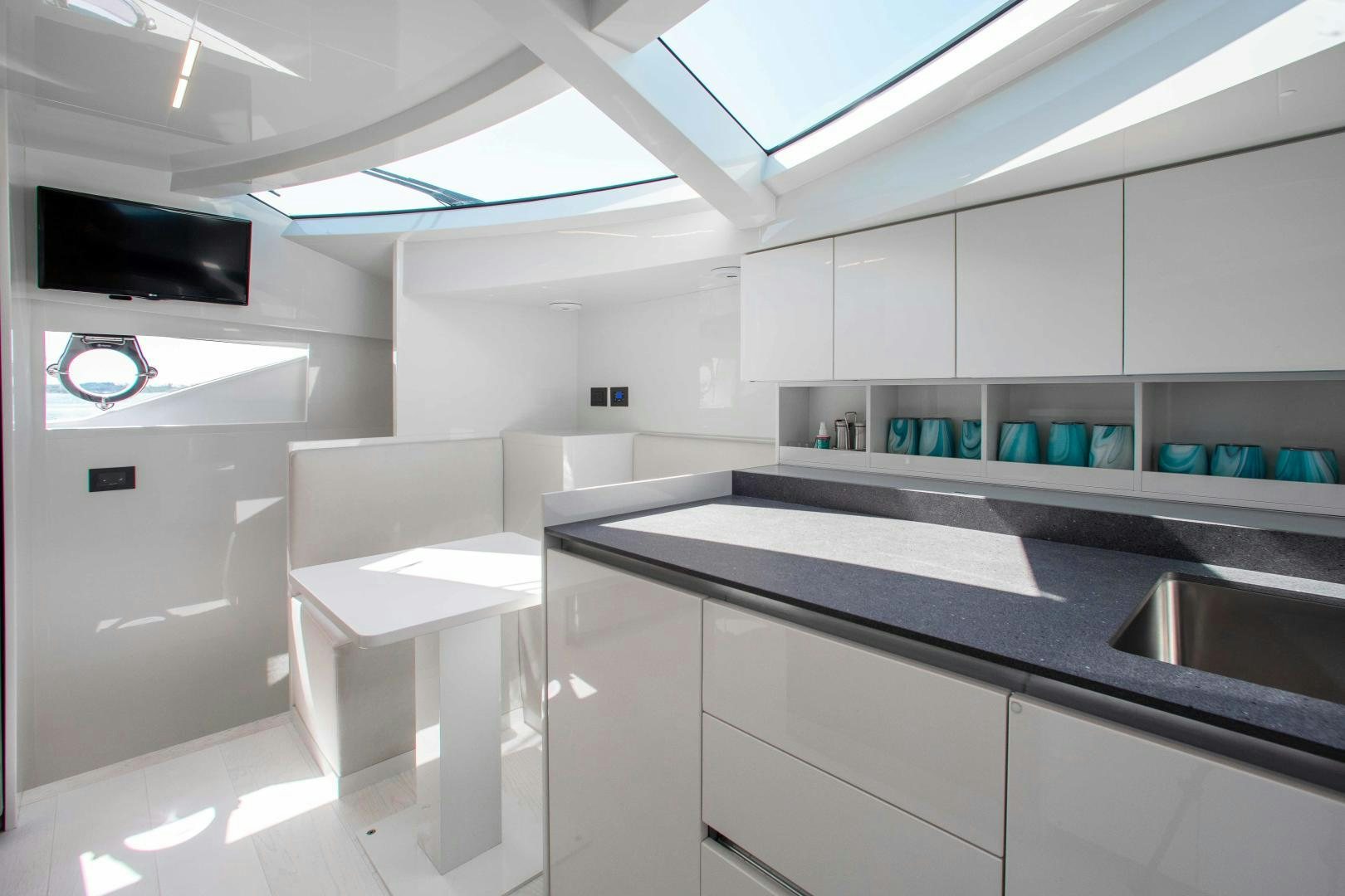 a kitchen with white cabinets aboard CRAZY Yacht for Sale