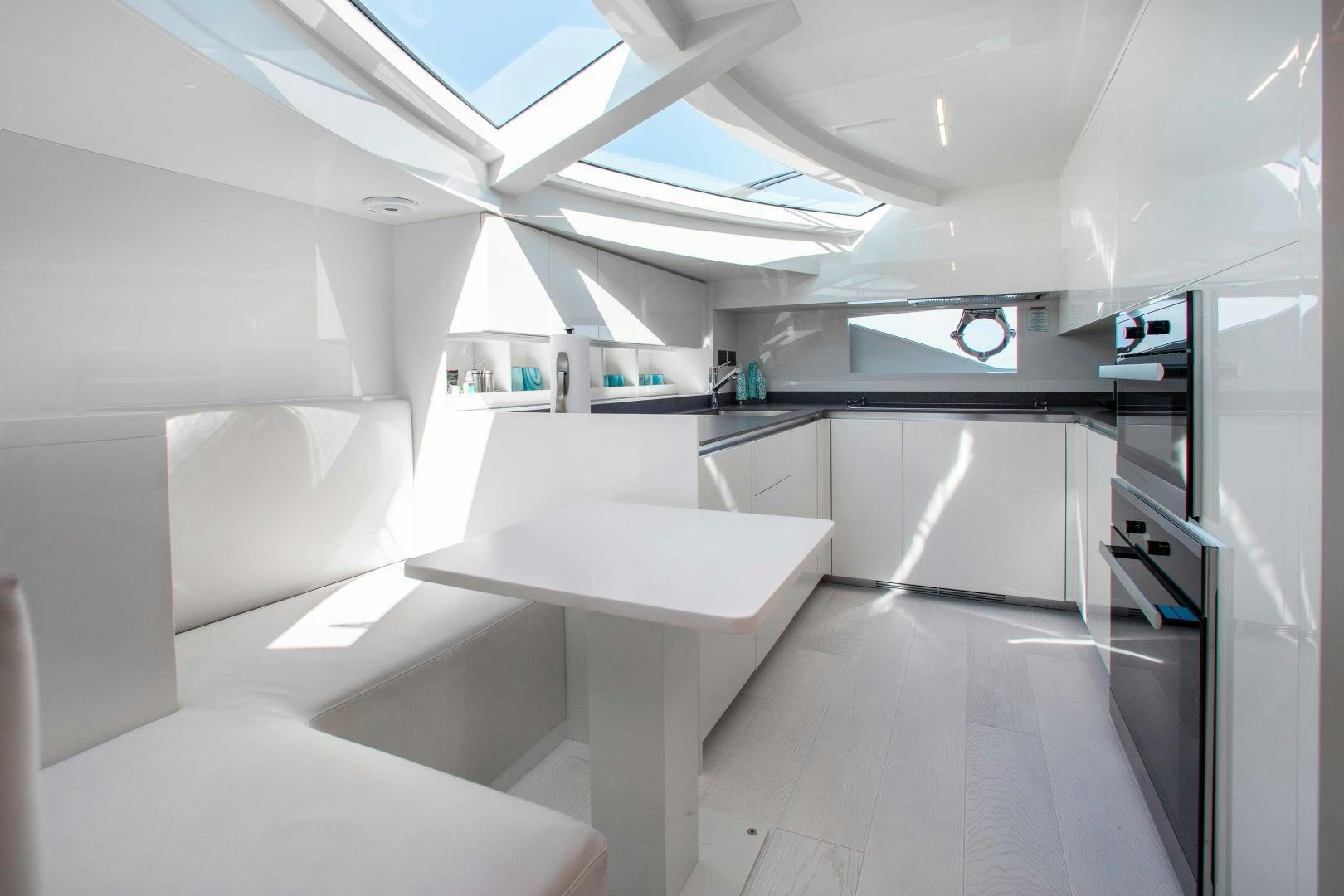 a room with a table and chairs aboard CRAZY Yacht for Sale