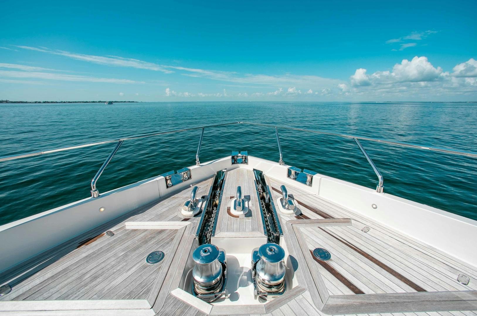 a deck with a large ship on it and a large body of water in the background aboard CRAZY Yacht for Sale