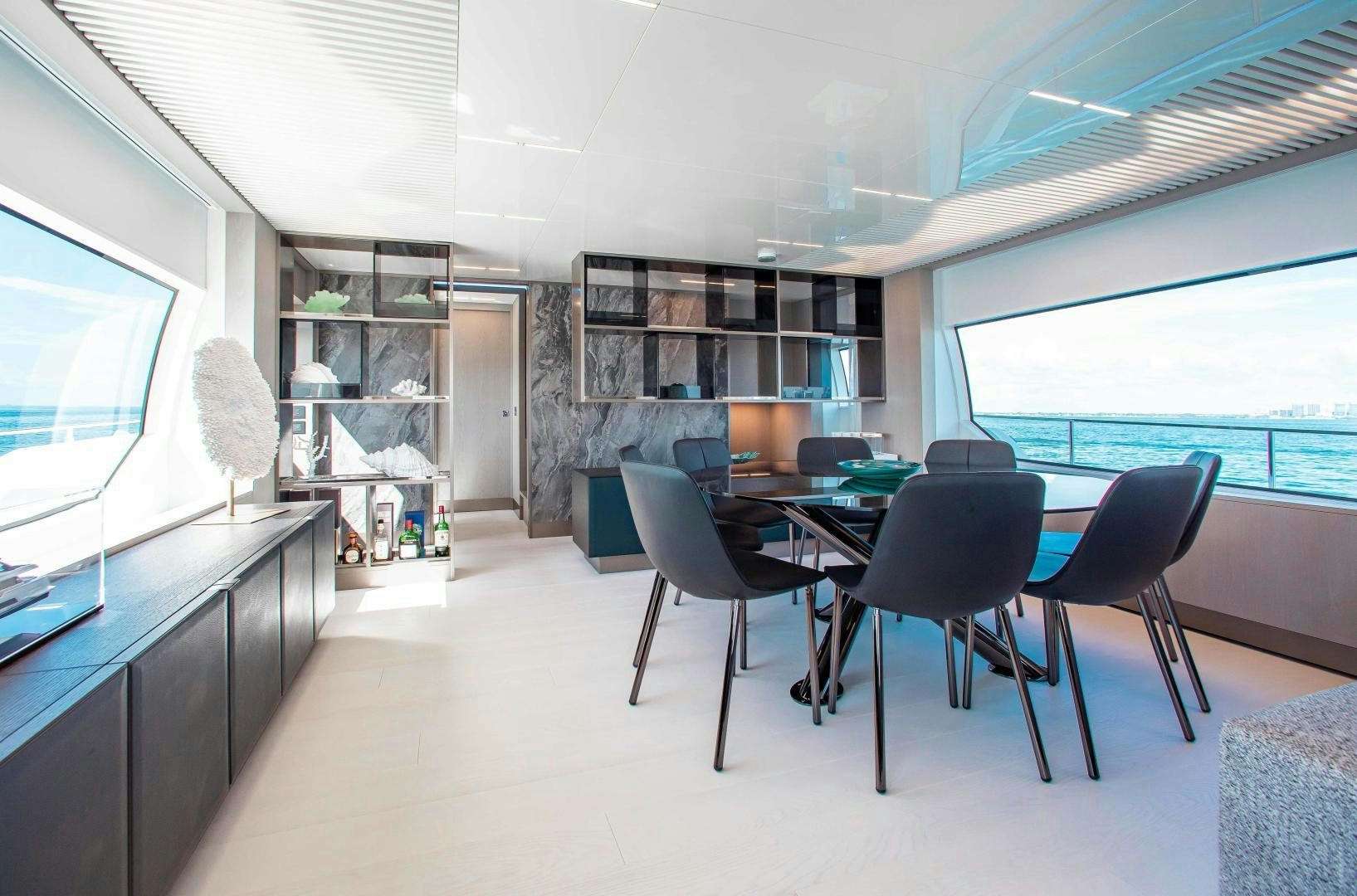 a room with a table and chairs aboard CRAZY Yacht for Sale