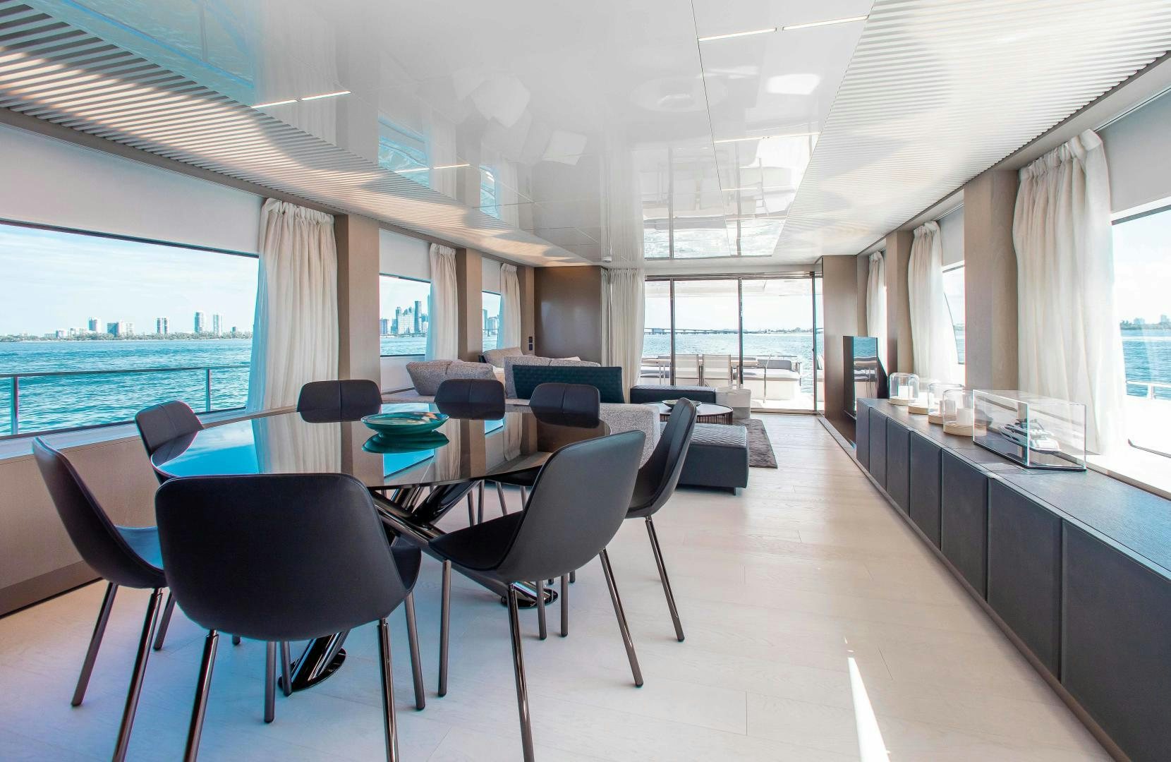 a room with tables and chairs aboard CRAZY Yacht for Sale