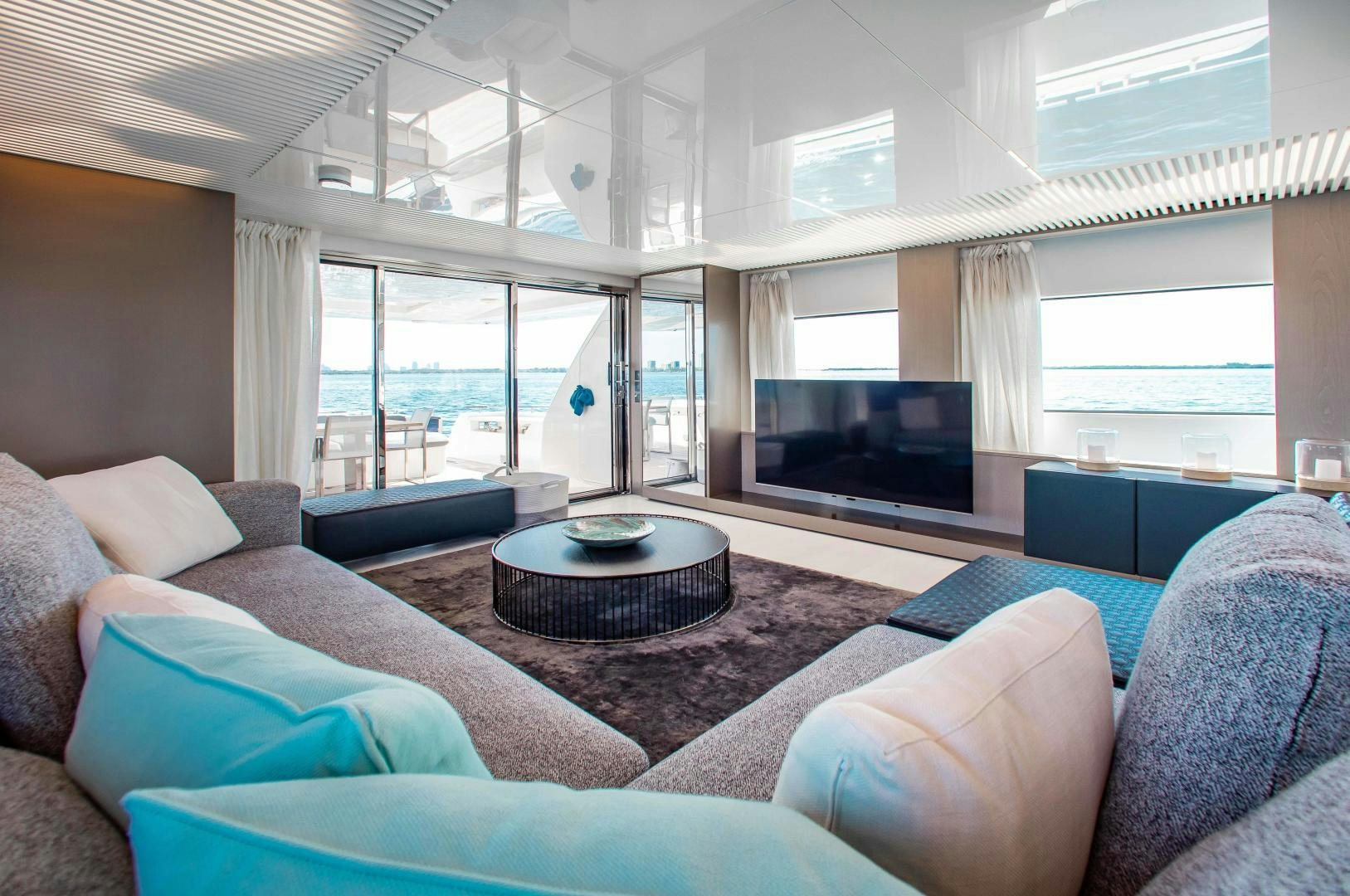 a living room with a large window aboard CRAZY Yacht for Sale