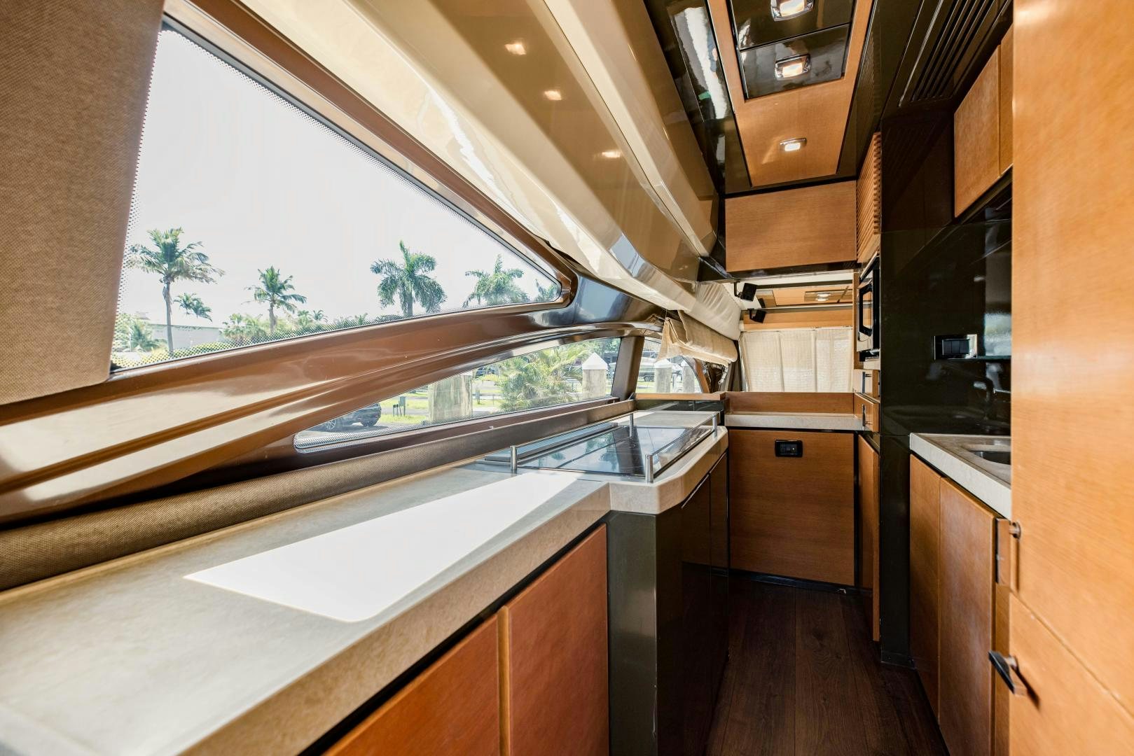 a kitchen with a large window aboard Azimut 70 Yacht for Sale