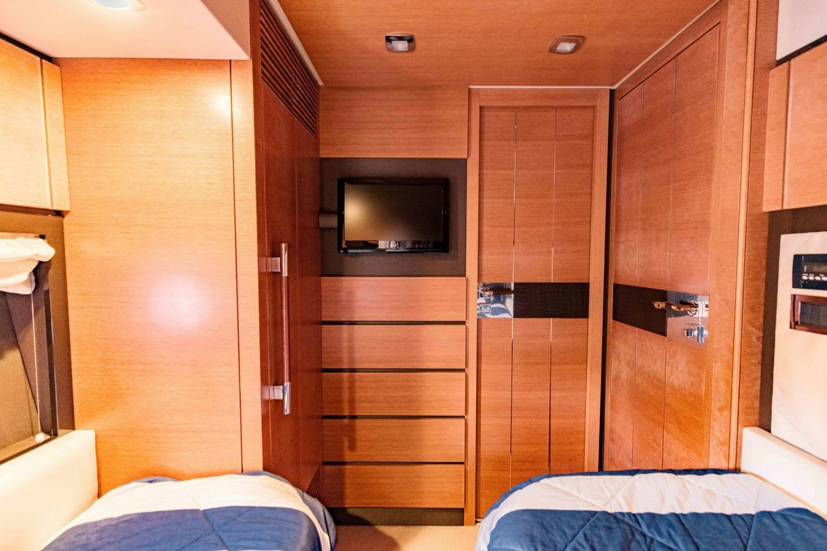 a room with a wood closet and a bed aboard Azimut 70 Yacht for Sale