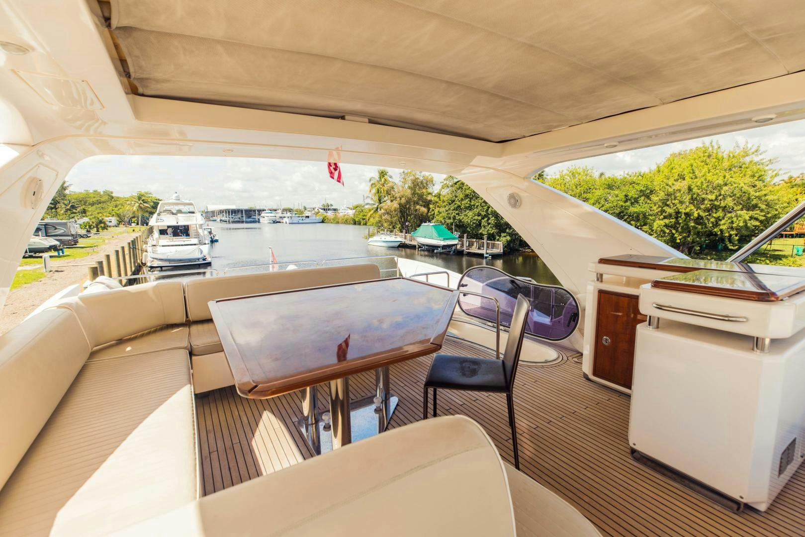 a room with a table chairs and a window with a view of a city aboard Azimut 70 Yacht for Sale