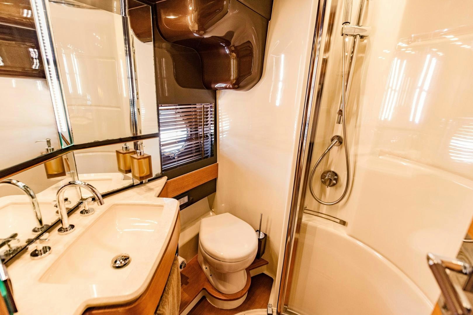 a bathroom with a toilet and bathtub aboard Azimut 70 Yacht for Sale