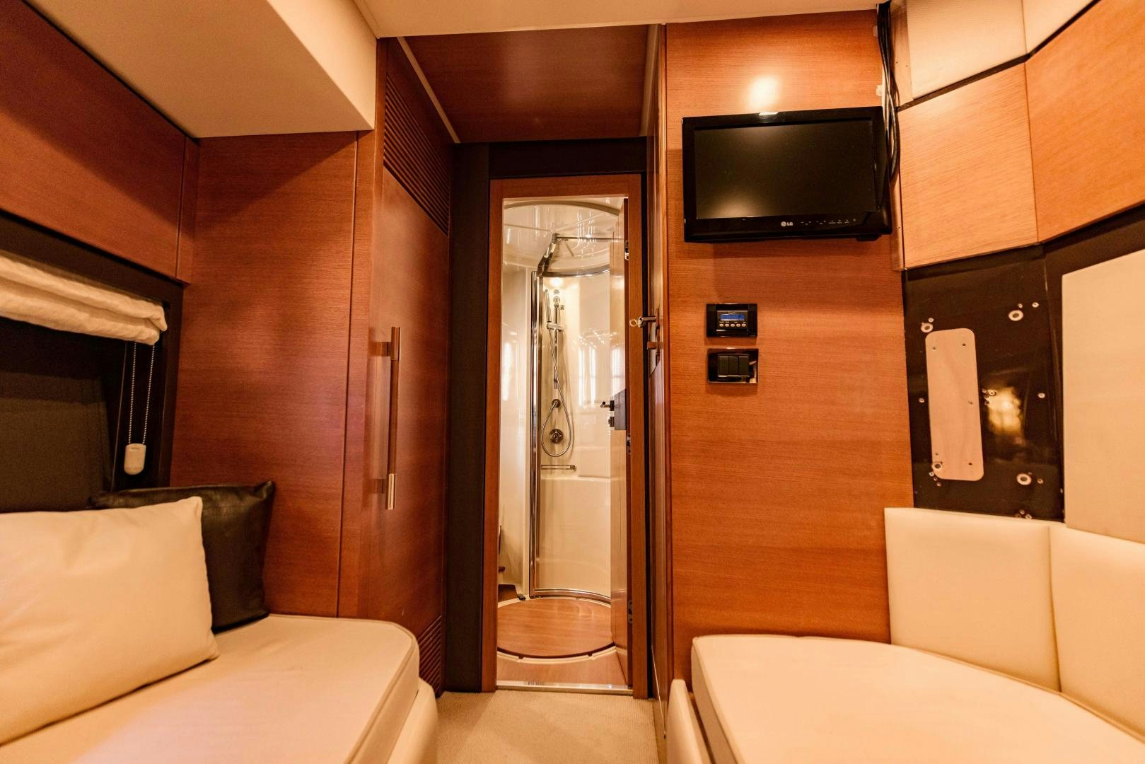 a room with a bed and a television aboard Azimut 70 Yacht for Sale
